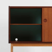 デンマーク製の小ぶりな北欧ビンテージボードで、チーク材とオーク材の組み合わせが上品な一台です。幅90cmとコンパクトながら、引き出し4杯とスライド扉付きの収納部を備え、実用性に優れています。丸いくり抜きの取っ手や直線的な脚部のデザインが軽快な印象を与え、どんな空間にも馴染みやすい造りです。背面の収納部には配線用の穴があり、オーディオや小型テレビ台としても活用可能です。経年により深みを増した木肌が、北欧家具ならではの味わいを感じさせます。