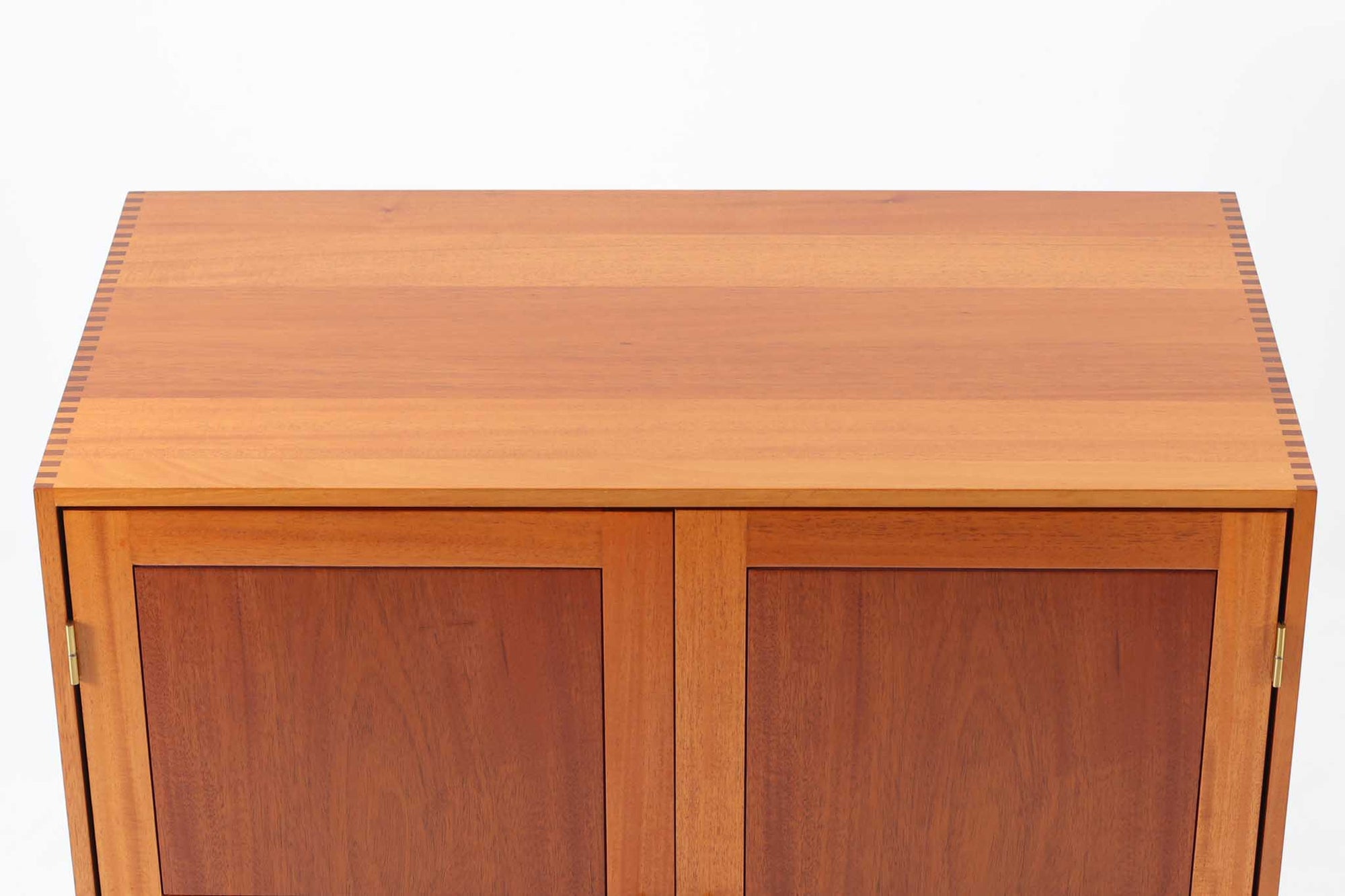 ビンテージ北欧家具の名門、デンマークのSoborg mobler社が手掛けたキャビネットです。デザイナーはChristian Hvidt（クリスチャン・ヴィッツ）。上質なマホガニー無垢材を贅沢に使用し、美しい木目と落ち着いた色合いが特徴的です。扉の意匠は4枚のパネルで構成され、シンプルながらも端正な印象を与えます。内部は左側に棚板、右側に引き出しを配置した実用的な収納設計。特にフレームや引き出しには指物（さしもの）による堅牢な組み方が施されており、デンマークの確かな家具製作技術を感じられます。脚付きのスタイルは床との間に適度な空間を作り出し、重厚な本体でありながら軽やかな印象を演出しています。リビングやダイニングルームでの使用に最適な、機能性とデザイン性を兼ね備えた逸品です。