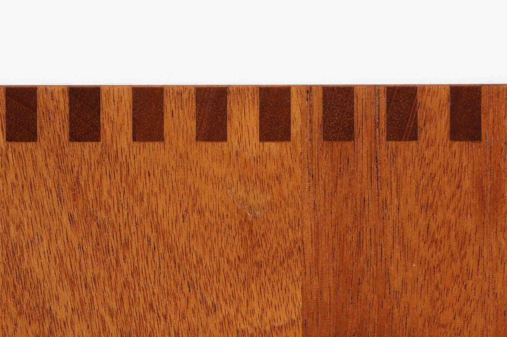 ビンテージ北欧家具の名門、デンマークのSoborg mobler社が手掛けたキャビネットです。デザイナーはChristian Hvidt（クリスチャン・ヴィッツ）。上質なマホガニー無垢材を贅沢に使用し、美しい木目と落ち着いた色合いが特徴的です。扉の意匠は4枚のパネルで構成され、シンプルながらも端正な印象を与えます。内部は左側に棚板、右側に引き出しを配置した実用的な収納設計。特にフレームや引き出しには指物（さしもの）による堅牢な組み方が施されており、デンマークの確かな家具製作技術を感じられます。脚付きのスタイルは床との間に適度な空間を作り出し、重厚な本体でありながら軽やかな印象を演出しています。リビングやダイニングルームでの使用に最適な、機能性とデザイン性を兼ね備えた逸品です。