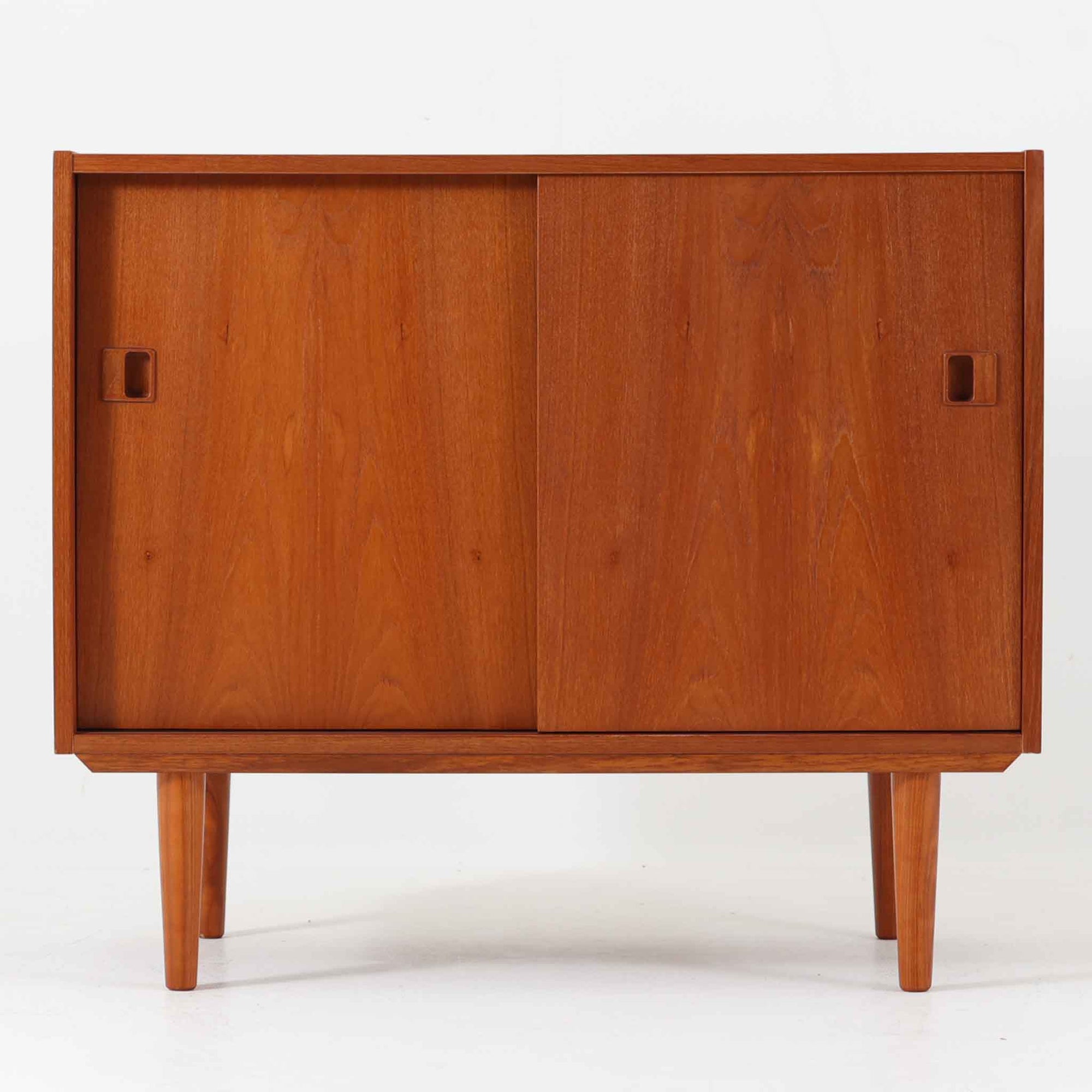 幅88cmとコンパクトなサイズ感が魅力のローボードは、温かみのあるチーク材を用いた北欧ビンテージ品で、丸みを帯びた脚部やシンプルなスライド扉が全体の柔らかな印象を引き立てています。リビングや寝室の収納、テレビボードとしても使いやすく、北欧らしい上品で控えめな佇まいが空間に自然に溶け込みます。