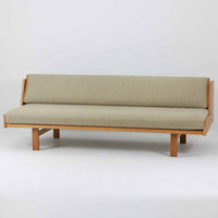 Hans J. WegnerがGetamaのためにデザインしたGE258デイベッド。オーク材の明るく上品な木肌と角脚の端正なフォルムが美しく、直線を基調としたミニマルな構造にウェグナーらしい機能美が息づいています。背もたれを倒すことでベッドとしても使用できる実用的な設計で、リビングでは洗練されたソファ、書斎やゲストルームでは簡易ベッドとしても活躍。経年により深まったオークの味わいとGetamaならではの堅牢なつくりが、北欧ビンテージらしい存在感と希少性を高める一台です。