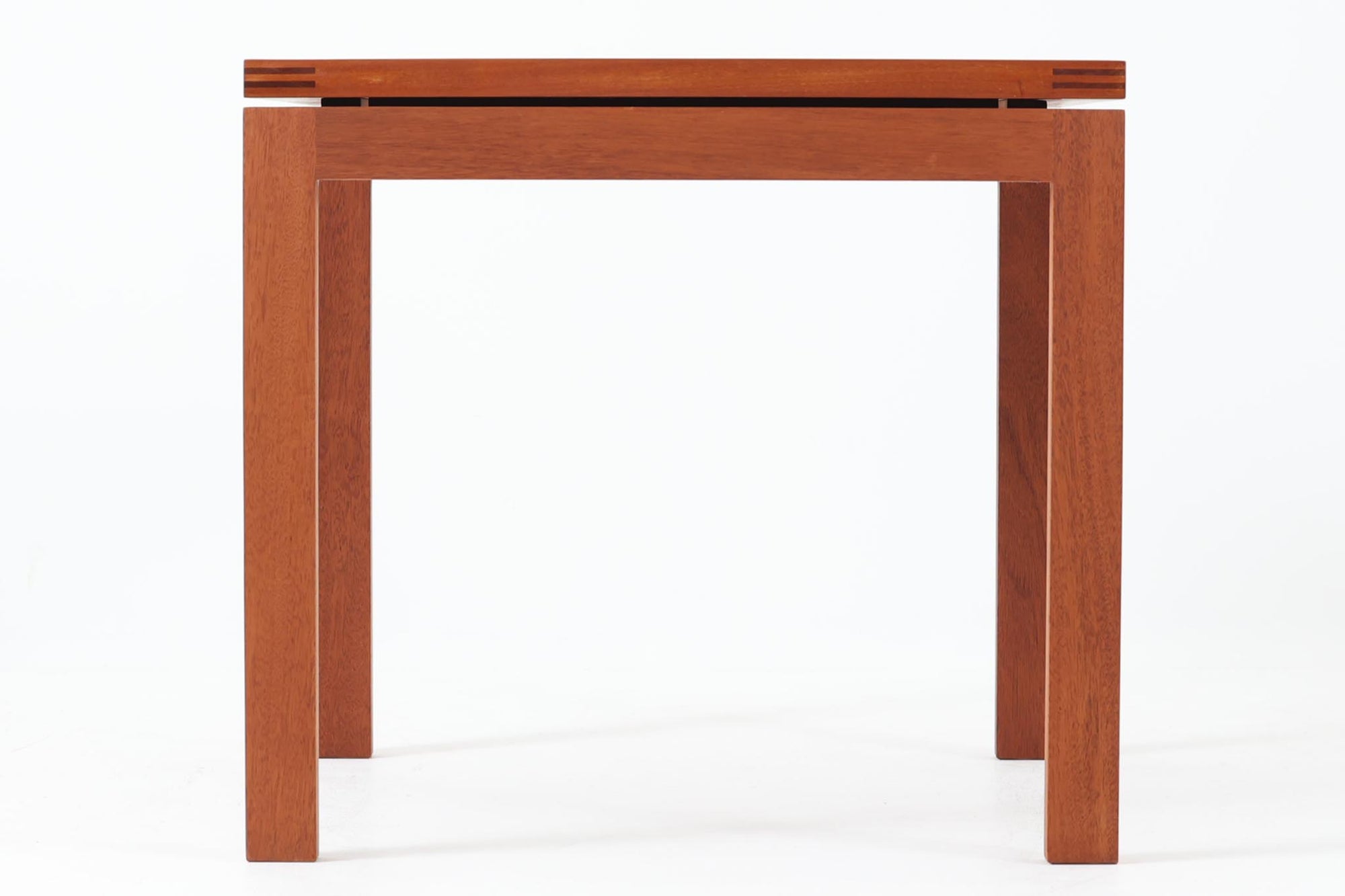 デンマークの老舗家具メーカー、munch mobler社製、Henning Jensen & Torben Valeurによるデザインの北欧ビンテージテーブルです。上質なマホガニー材を使用し、滑らかな木肌と深みのある赤褐色の色合いが上品な佇まいを演出します。天板と脚部には美しい留め加工が施されており、シンプルな構造の中に職人技が光るディテールが際立ちます。幅60cm×奥行60cmのサイズ感は、ソファサイドに置くサイドテーブルとしても、リビング中央でのセンターテーブルとしても使い勝手が良く、さまざまなシーンにフィットします。ミニマルでありながらも個性を感じさせる一台をお探しの方におすすめです。