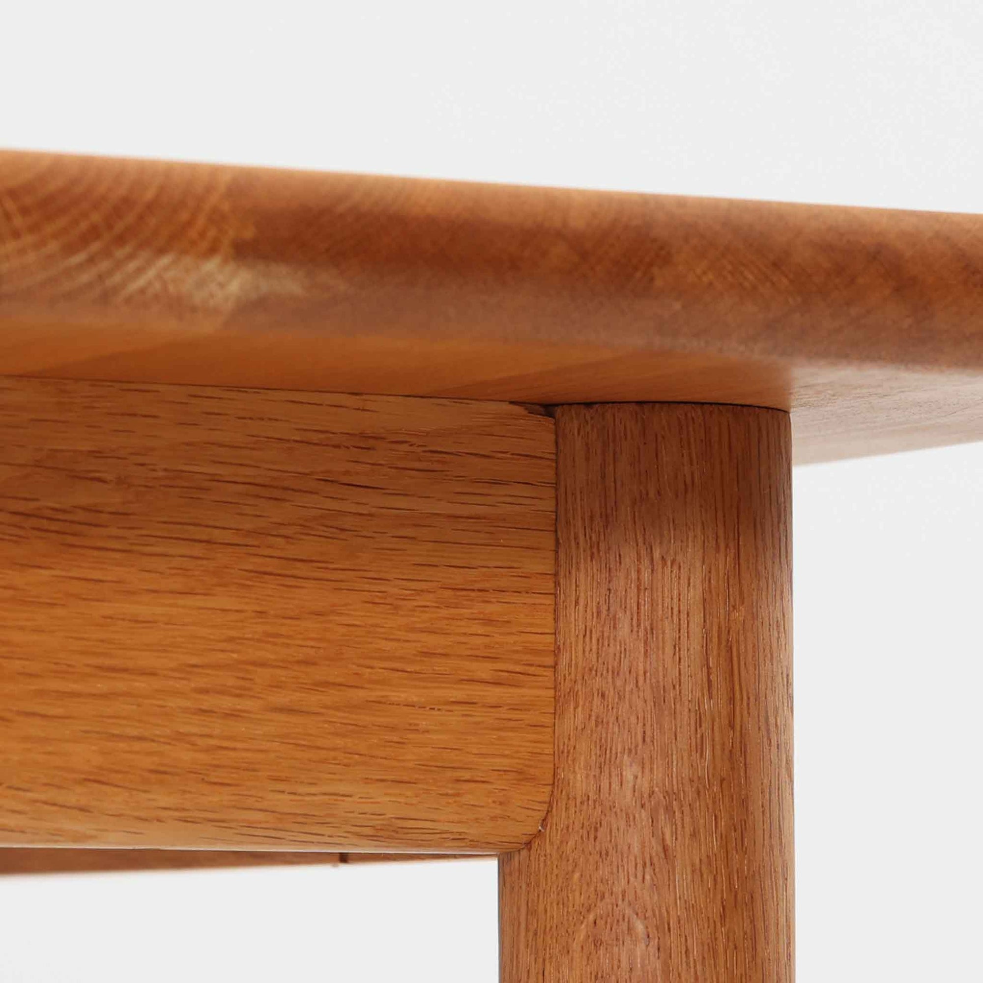 Hans J. WegnerがデザインしGetama社より製造されたGE80/86センターテーブルは、オーク無垢材を贅沢に使用した堅牢かつ端正な一台です。丸みを帯びた天板の縁や、すっきりとした円錐形の脚部が特徴で、シンプルでありながら温かみのある北欧デザインを体現しています。幅75cmと扱いやすいサイズ感で、リビングの中心に置いてコーヒーテーブルとしてはもちろん、サイドに添えても活躍する汎用性の高い家具です。経年による木肌の変化が深みを増し、ビンテージならではの存在感を放ちます。