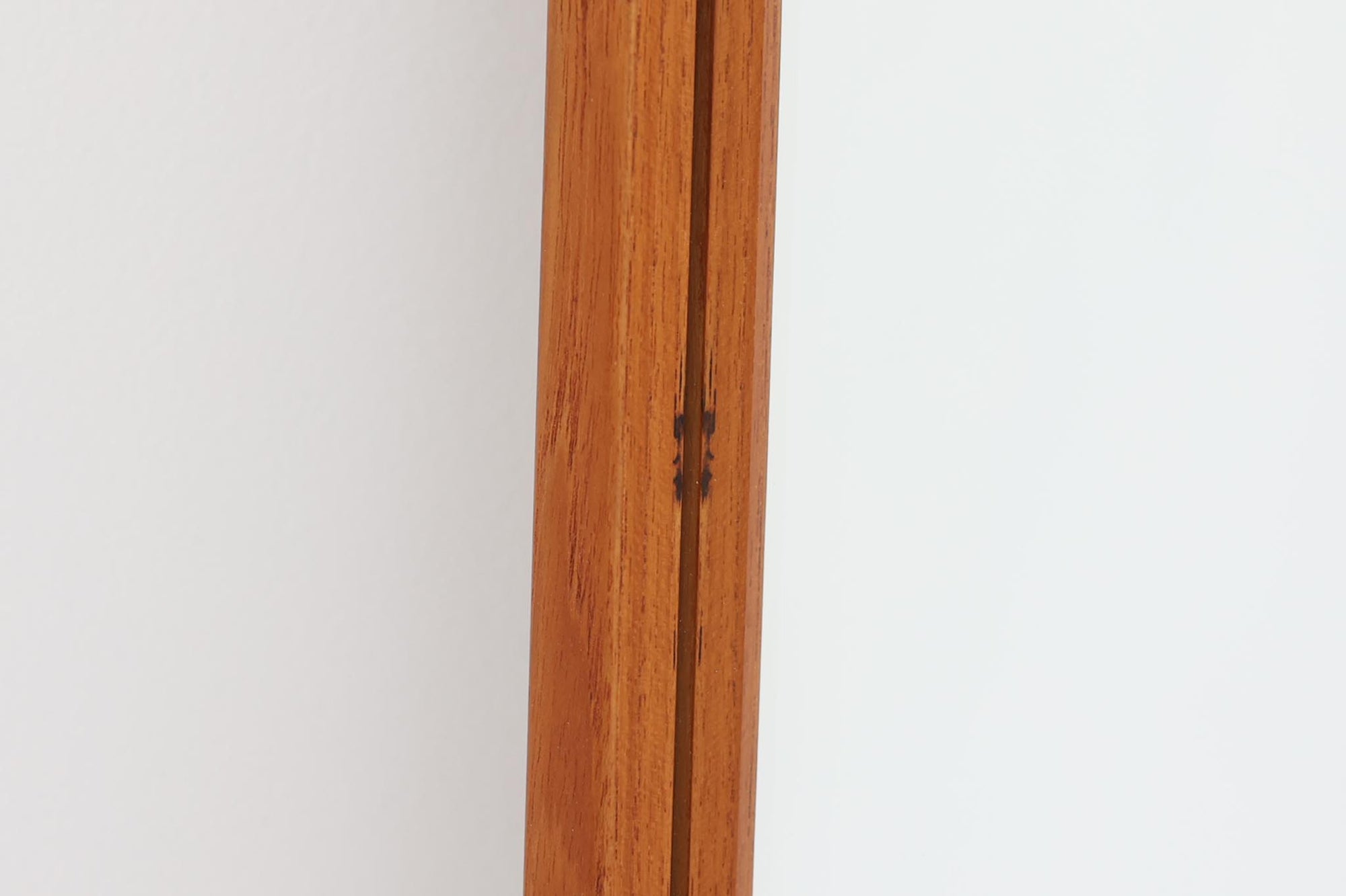 デンマークの家具ブランドAksel Kjersgaard（アクセル・キアスゴー）製、Kai Kristiansen（カイ・クリスチャンセン）デザインのビンテージミラーです。無垢チーク材による繊細でシャープなフレームが特徴で、丁寧な仕口や木目の美しさから高い品質が伺えます。幅29cmとスリムでありながら、高さ104cmと全身を映すのに十分なサイズ感があり、玄関や寝室など限られたスペースにもおすすめの一枚です。背面には「Aksel Kjersgaard ODDER」の焼印も確認できます。ビンテージ品のため経年によるわずかな使用感は見られますが、全体としては良好なコンディションを保っています。