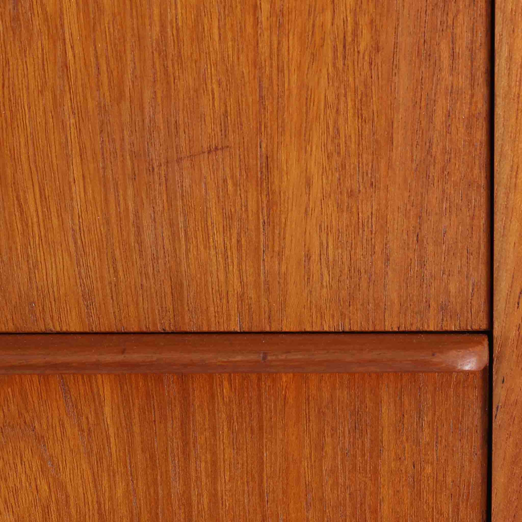 デンマーク製の8段チェストで、上質なチーク材の木目が存在感を放つ北欧ビンテージらしい一品です。細身の脚部に支えられた軽やかな佇まいと、北欧家具らしいバータイプの取っ手が、すっきりとした印象を与えます。衣類や小物をたっぷり収納でき、寝室やリビングで圧迫感なく使える点も魅力です。経年により深みを増した色艶が空間を温かく彩り、実用性と美しさを兼ね備えたチェストで、デンマークでも8段タイプは流通が少なく希少なモデルです。