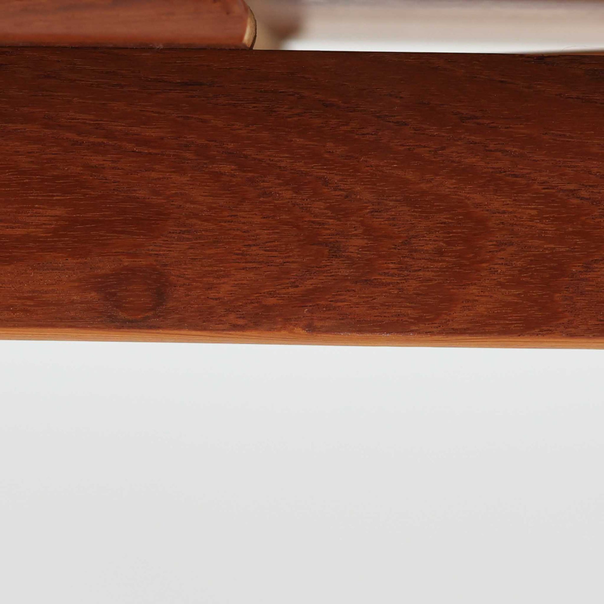 北欧らしい実用性と素材の良さが感じられる正方形エクステンションテーブルです。天板には良質なチーク材が用いられ、赤みのある木目と滑らかな手触りが、経年変化による深みとともに味わいを増しています。通常時はコンパクトなサイズ感で使いやすく、左右の補助天板を引き出すことで来客時や食事人数に応じて柔軟に対応できる構造です。脚部は細身で圧迫感がなく、幕板の緩やかな曲線が全体にやわらかな印象を与え、ダイニングはもちろんワークテーブルとしてもおすすめです。