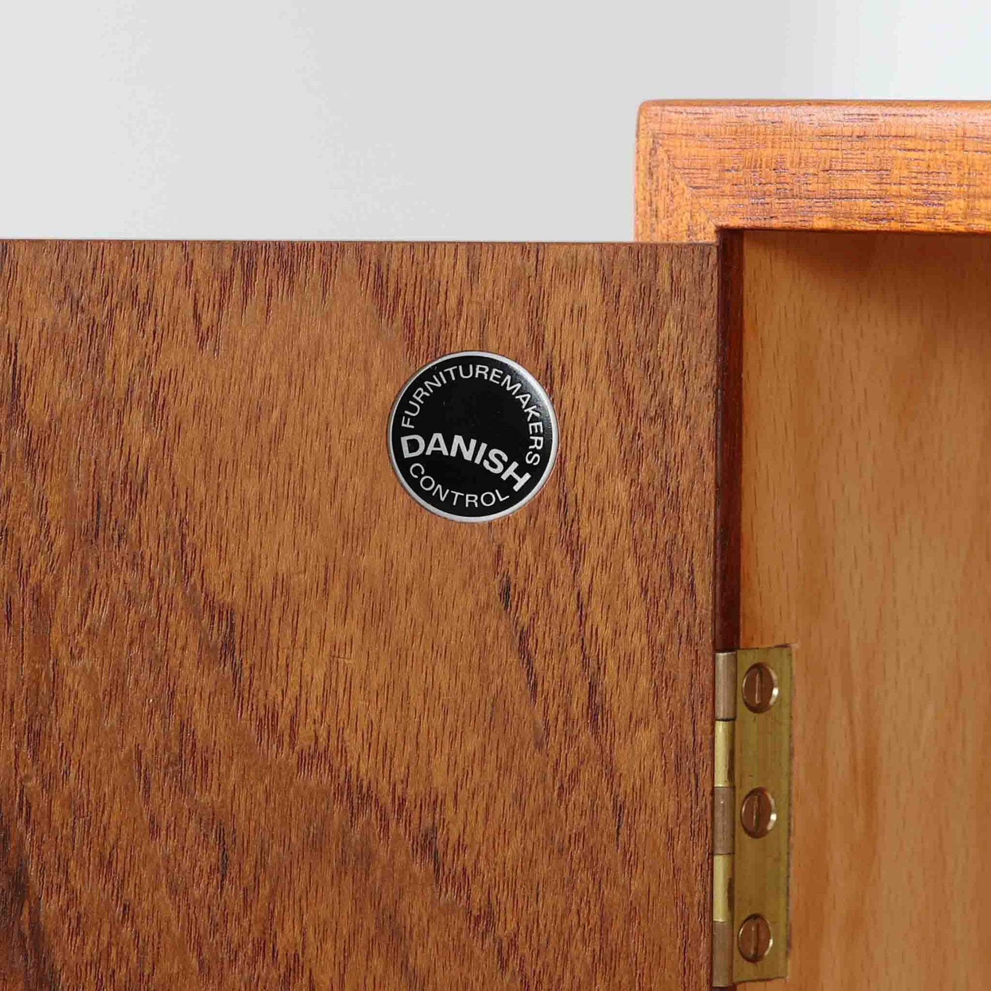 デンマークの巨匠Hans J. Wegner（ハンス・J・ウェグナー）がRY Mobler社のためにデザインしたディスプレイシェルフ「RY5 / RY15」です。上質なチーク材とオーク材を組み合わせ、下段収納部の取手には真鍮を用いた精緻なつくりが特徴です。シンプルながらも素材の美しさが際立ち、ウェグナーらしい温かみのあるデザインに仕上がっています。上段の棚は高さ調整が可能で、下段には仕切り付きの収納スペースを備え、実用性にも優れます。経年により深みを増した木肌の風合いが美しく、リビングや書斎で本や器を飾るなど、多用途に活躍する北欧ビンテージ家具です。