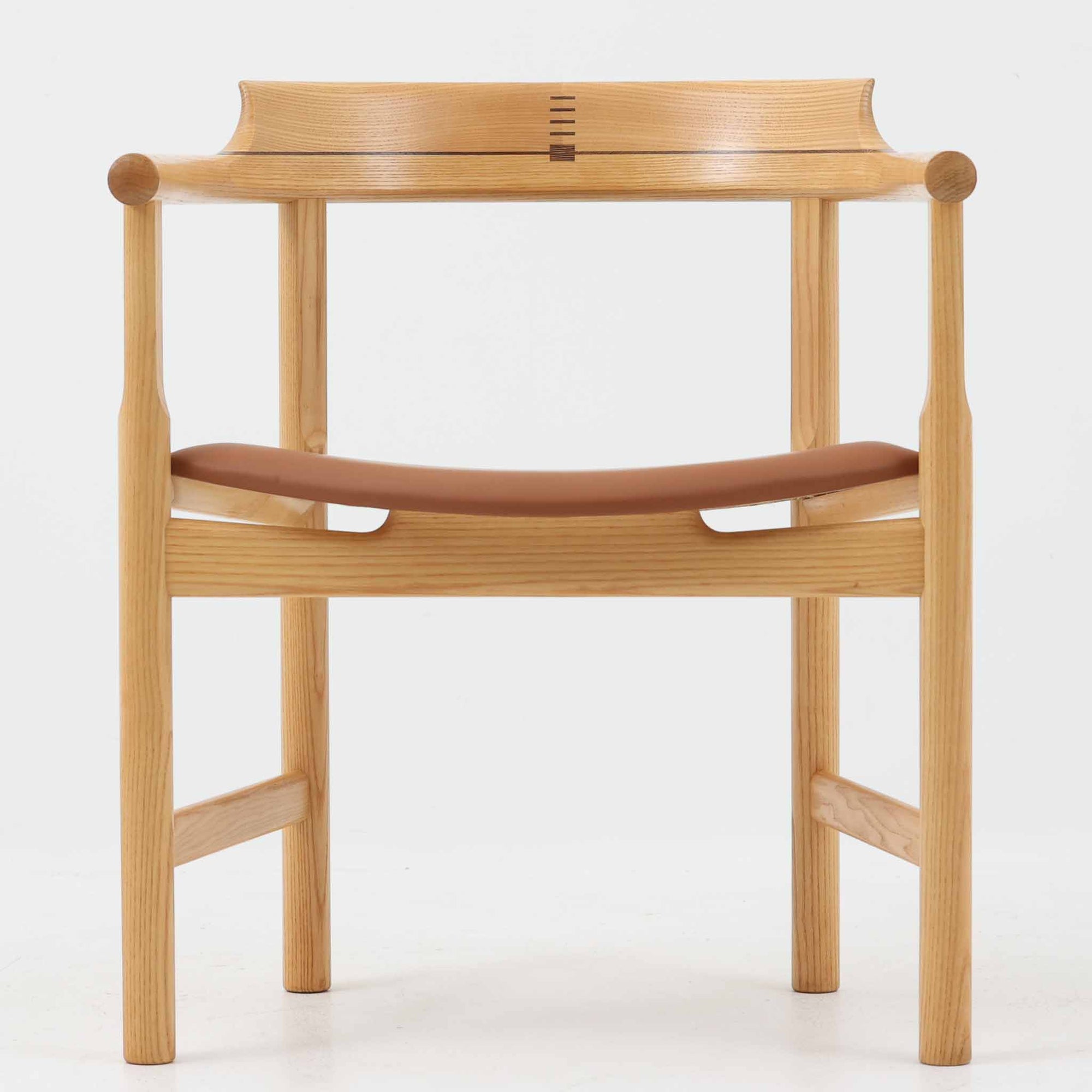 Hans J. Wegnerが1975年にデザインし、PP Mobler社が製造したPP52 Captain's Chairは、背からアームまで滑らかにつながる一体成型の美しいフォルムが魅力のアームチェアです。素材には木目の美しいアッシュ材と本革が用いられ、背面には象徴的な埋木の意匠が施されています。座面はゆったりとしたカーブで快適な座り心地を実現し、ダイニングからデスクシーンまで幅広く対応します。現在も製造されており、現行品の販売価格は約90～100万円程度となっています。