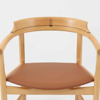 Hans J. Wegnerが1975年にデザインし、PP Mobler社が製造したPP52 Captain's Chairは、背からアームまで滑らかにつながる一体成型の美しいフォルムが魅力のアームチェアです。素材には木目の美しいアッシュ材と本革が用いられ、背面には象徴的な埋木の意匠が施されています。座面はゆったりとしたカーブで快適な座り心地を実現し、ダイニングからデスクシーンまで幅広く対応します。現在も製造されており、現行品の販売価格は約90～100万円程度となっています。