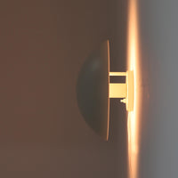 Poul Henningsenがデザインし、Louis Poulsen社から発表されたウォールランプ「PH ハット」直径30cmです。スチール製の半円形シェードは内側を淡いピンク色に仕上げ、点灯時には柔らかで温かみのある光を壁面に広げます。シンプルながら緻密に計算された光の効果はヘニングセンならではの魅力で、寝室や廊下、リビングの補助照明として最適です。1950年代に誕生したモデルは現在でも高く評価されており、ビンテージならではの風合いと希少性を備えています。元々は2サイズ展開で、本品は現行品には存在しない大サイズの希少モデルです。