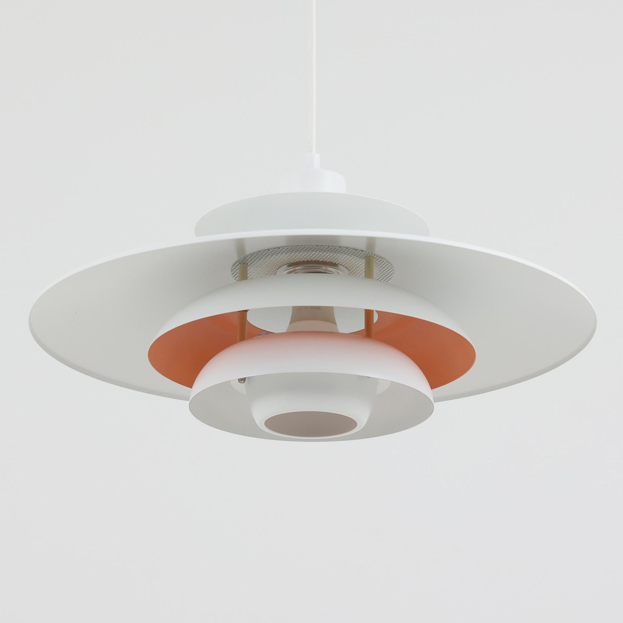 Jeka Metaltryk社製のペンダントライト「Sofie」です。直径48cmと大きめのサイズで、複数枚のシェードを重ねた構造が特徴的です。スチール素材のしっかりとした造りで、点灯時には光が柔らかく分散し、眩しさを抑えつつ空間を明るく照らします。内側に施された温かみのある色合いが、照明に柔らかなニュアンスを加え、ダイニングやリビングのメインライトとして存在感を放ちます。シンプルながらも洗練された北欧デザインを感じさせるビンテージアイテムです。