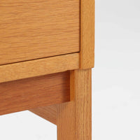 北欧らしい合理性と温もりを感じさせるスリムシェルフです。オーク材ならではの明るく素直な木目が全体に美しく広がり、経年によって落ち着いた表情へと変化しています。上部は抜け感のあるオープン棚構造で、書籍やオブジェ、器などを軽やかにディスプレイ可能。下部には4段の引き出しを備え、小物や生活用品をすっきりと収納できます。幅60cmのスリムな設計は、リビングや書斎、寝室など限られたスペースにも取り入れやすく、収納と飾る楽しみを両立できる北欧ビンテージならではの実用的な一台です。