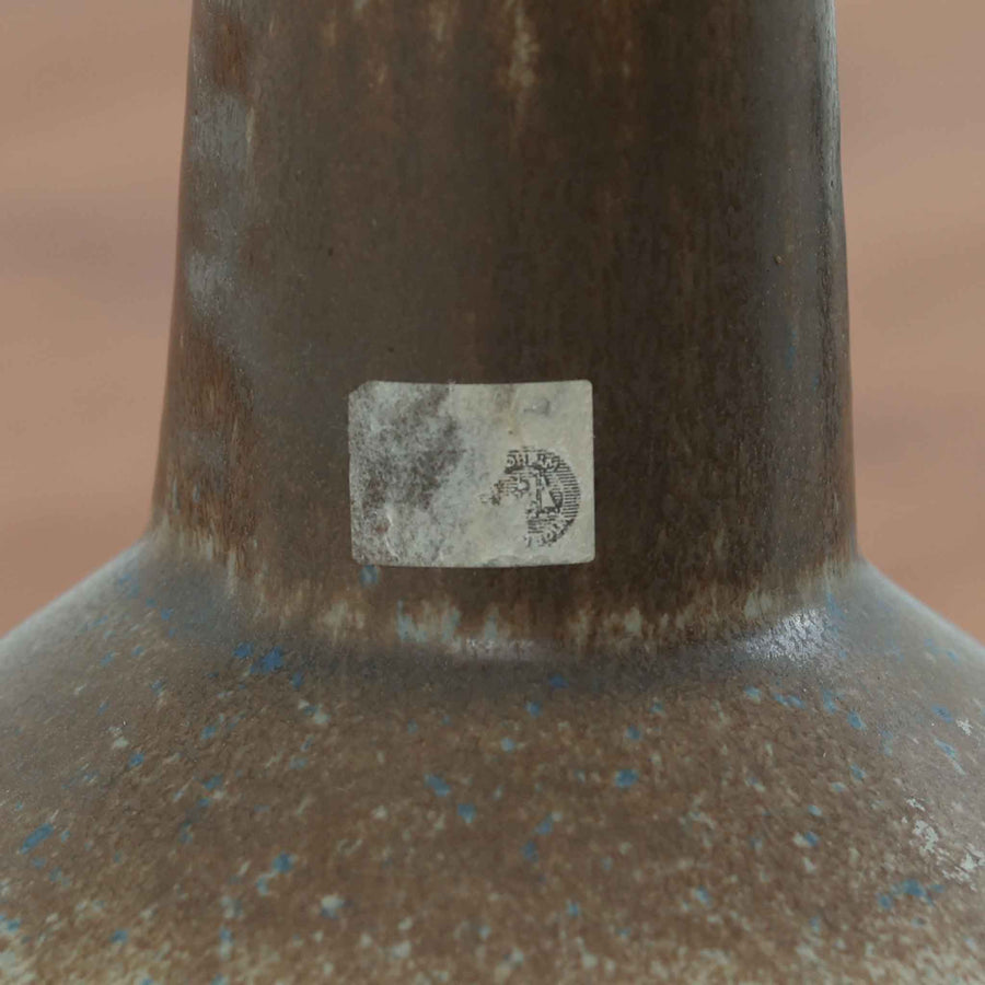 スーホルム・セラミック社製のこちらのテーブルランプは、デンマークで製造された北欧ビンテージ品で、高さ44cmと存在感のあるサイズ感が魅力です。陶磁器のベースには幾何学的なレリーフ模様が施され、釉薬の自然なグラデーションがビンテージらしい風合いを引き立てています。リネンシェードを通した柔らかな光は温かみを帯び、リビングやベッドサイドに心地よい雰囲気をもたらします。年月を経て深みを増した質感と、クラフトマンシップを感じさせる一点物ならではの魅力をお楽しみいただけます。