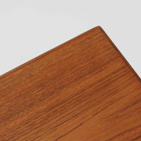 チーク材を用いたデンマーク製の拡張板付きセンターテーブルです。直線的で軽やかなフレーム構造と、脚部から天板へとつながる端正な接合部に北欧ビンテージらしい丁寧なつくりが感じられます。拡張板を引き出すことで天板幅を大きく広げることができ、来客時や作業スペースとしても柔軟に対応します。深みを増したチークの色合いと美しい木目が空間に落ち着きを与え、リビングの主役として長く愛用できる一台です。拡張板はチーク材のほか、黒のラミネート仕上げの2種類が備わっており、用途に応じて使い分けが可能です。ラミネート面は輪染みがつきにくく、作業用や来客時にも気兼ねなく使える実用性を備えています。