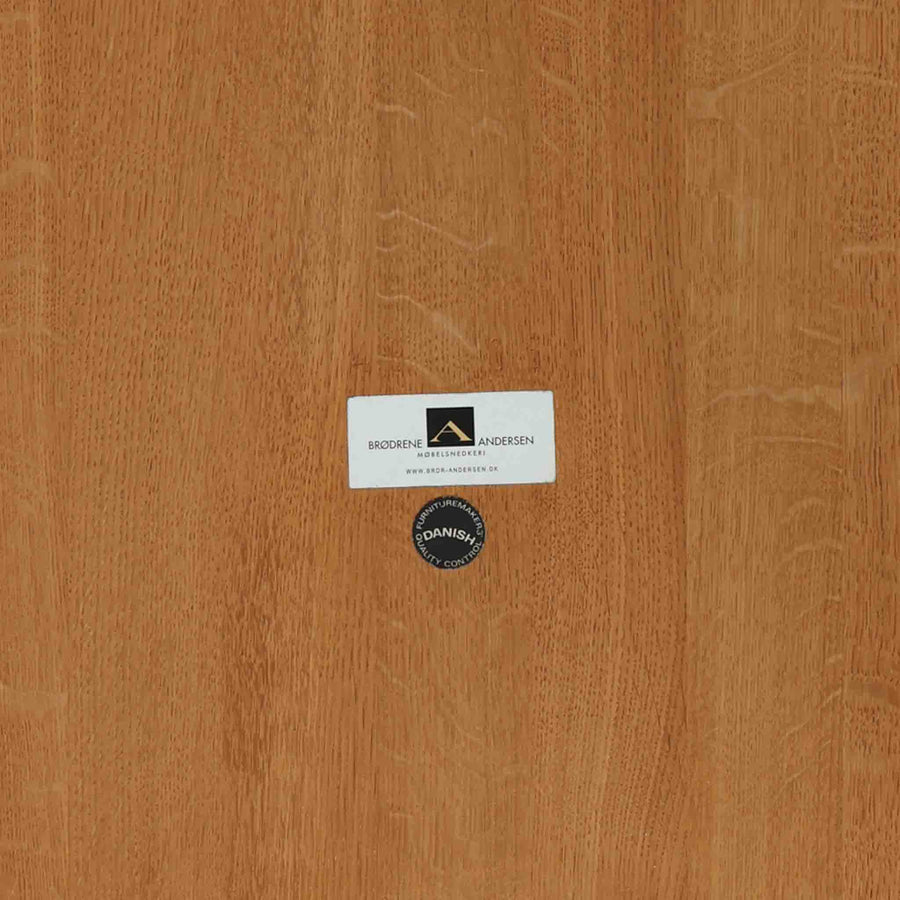 デンマークの家具メーカーBrodrene Andersen（ブロデルネ・アンデルセン）によるオーク無垢材のダイニングテーブルです。すっきりとした直線的な脚部と控えめな面取りが施された天板が美しく、素材の質感と職人技が際立つ仕上がりです。堅牢でありながら軽やかな印象を持ち、オーク特有の温かみある色調が空間に自然と馴染みます。幅115cmのコンパクトサイズで、ダイニングだけでなくワークデスクとしても使いやすい一台。北欧らしいシンプルなデザインと確かな作りが魅力のビンテージテーブルです。