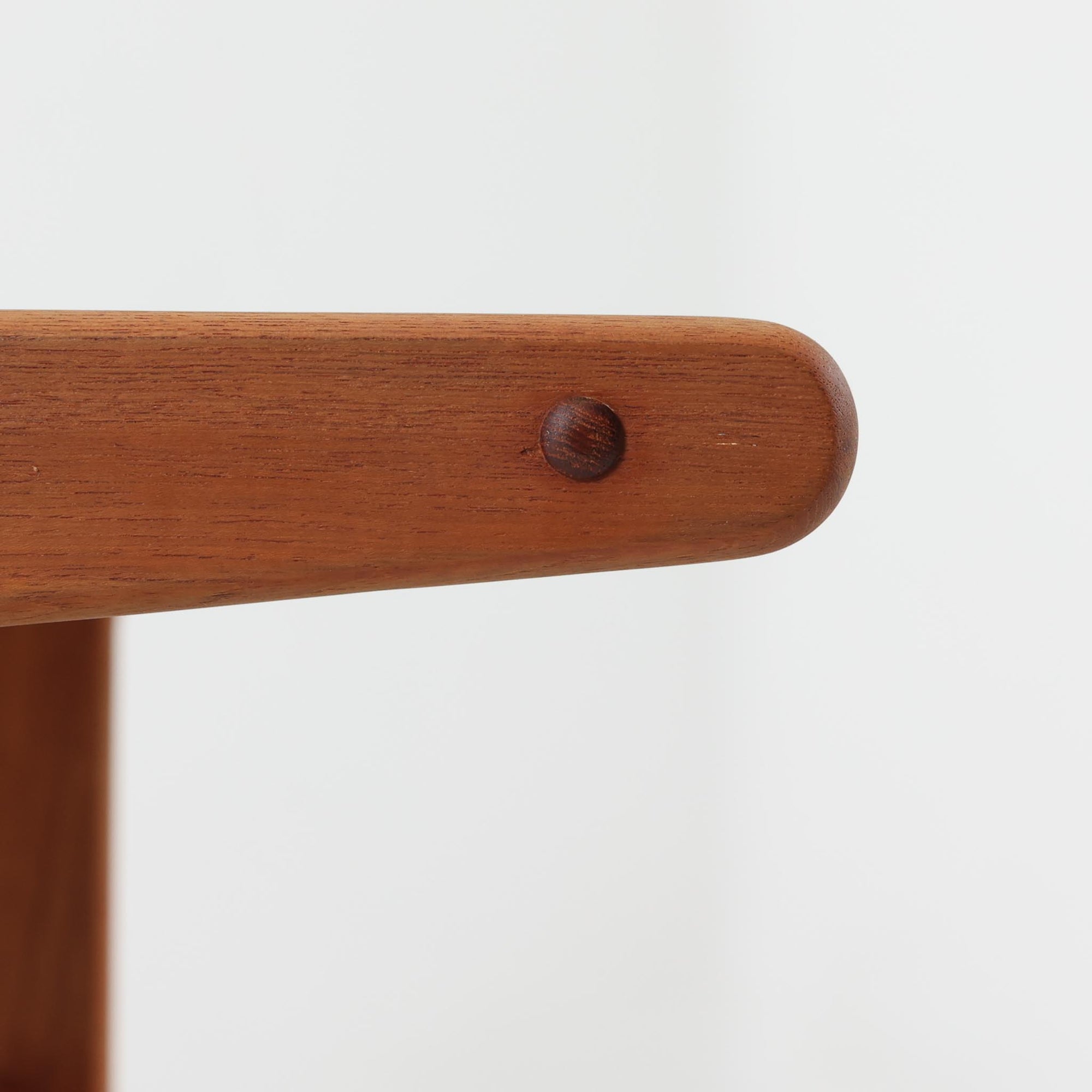 北欧ビンテージらしい合理性と温もりを感じさせるネストテーブルで、上下に重ねて使える構造により、限られた空間でも柔軟な使い方ができる実用的な一式です。素材には良質なチーク材が用いられ、木目の美しさと滑らかな手触りが際立ち、側板や脚部に見られるやわらかな曲線が全体に軽やかな印象を与えています。ネストテーブルではありますが、上下は深く内部に収まる仕様ではなく、軽く差し込む程度の構造となっており、単体でサイドテーブルや花台として使うほか、来客時には引き出して補助天板としても活躍します。経年変化によって深みを増した木肌が、空間に落ち着きと上質感をもたらします。