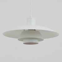 北欧より買い付けたLouis Poulsen社製「PH4」は、Poul Henningsenによる名作照明で、直径40cmの程よいサイズとアルミの軽やかな質感が魅力です。PH5と並ぶ人気を誇り、3枚シェード構造が光を柔らかく拡散し落ち着いた空間を演出します。経年の風合いも楽しめ、ダイニングやリビング、書斎や寝室まで幅広く活躍するビンテージ品です。