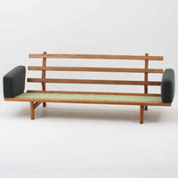 Hans J. Wegnerがデザインし、Getamaより製作された「GE236」トリプルソファです。オーク材のフレームに、背面の横桟が美しく並ぶ構造が特徴で、後ろ姿まで洗練された佇まいを見せるウェグナーらしいデザイン。クッション内部にはスプリングが内包されており、程よい弾力と快適な座り心地を実現しています。落ち着いた色合いの張地が木部の温かな表情を引き立てる、北欧ビンテージを代表する名作ソファです。