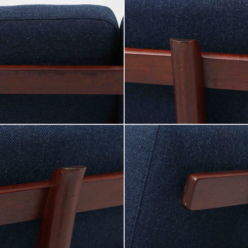 こちらは、ウェグナーデザインの人気モデル、GE236の3人掛けソファです。後ろ姿が非常に美しいため、あえて壁に寄せず背面を見せる配置もおすすめです。クッション内部にはスプリングが内蔵されており、座り心地も良好です。さらに、こちらは現地でも希少なアフロモシア材（通称アフリカンチーク）が使用された特別なモデルです。GE236のチーク材仕様として一般的に認識されているのは、このアフロモシア材が使用されたモデルを指します。GETAMA社の刻印も確認できます。