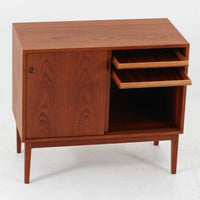 デンマーク製ローボードです。チーク材ならではの赤みを帯びた美しい木目が前面にあらわれ、引き戸には掘り込み式の丸い取っ手を配したミニマルな意匠が北欧らしい静かな存在感を放ちます。幅80cmの小ぶりなサイズ感で、リビングのテレビ台としてはもちろん、書斎やベッドルームでの収納家具としても取り入れやすく、内部には棚板を備え実用性も十分です。経年によって深みを増した木肌の表情と丁寧なつくりが、ビンテージならではの温もりを空間に添えてくれる一台です。