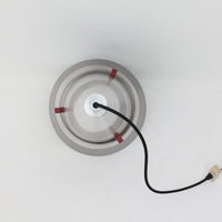 Jo HammerborgがFog & Morupのために手掛けた「Corona」は、直径22cmとコンパクトながら全高45cmと縦にしっかりとした存在感を持つアルミ×スチール製ペンダントライトで、上下に伸びる円錐形フォルムと中央のブラックバンドが彫刻的な印象を与える北欧ビンテージ品です。光源を囲む二重構造によって眩しさを抑えつつ下方向へ明かりを集中的に落とす設計となっており、ダイニングやカウンター上での1灯使用はもちろん、複数灯を並べても空間にリズムを生み出します。経年で深まった素材の風合いがハーマボーらしいモダンな佇まいを際立たせ、空間のアクセントとしても十分な存在感を発揮します。