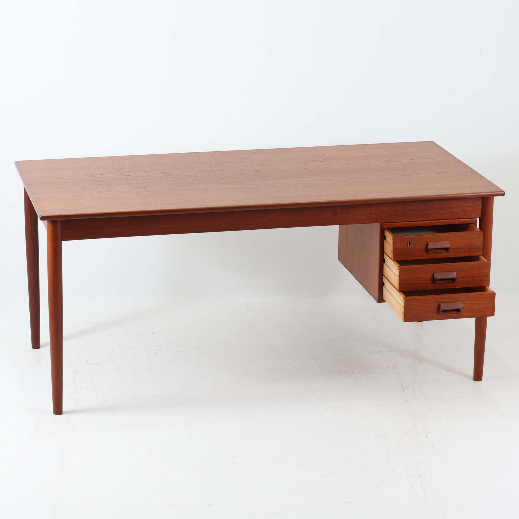 Soborg Mobler社製、Borge Mogensen（ボーエ・モーエンセン）デザインの片袖デスクで、直線的で端正な佇まいと丸脚の柔らかなラインが上品なバランスを生み、深みのあるチーク材が空間に落ち着いた雰囲気を与えます。右側には3段の引き出しが配置され、文具や書類、小物の整理に使いやすく、ワークデスクや書斎机としてはもちろん、ショップのカウンターテーブルとしても相性が良く幅広いシーンで活躍します。北欧ビンテージらしい温かみと実用性を備え、経年による風合いを楽しみながら長くご使用いただける一品です。