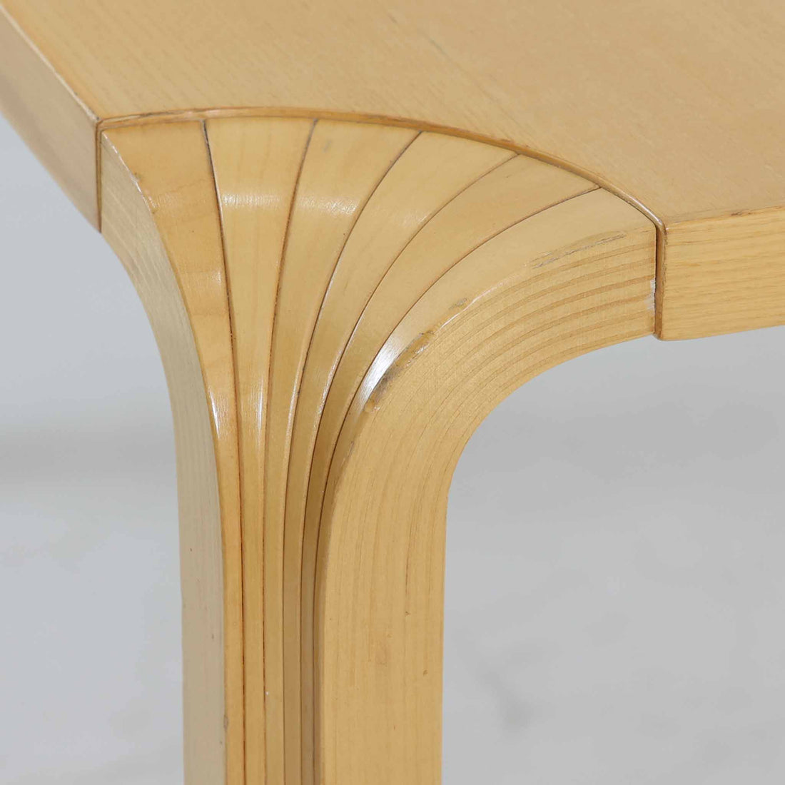 フィンランドを代表する建築家アルヴァ・アアルトによるデザイン、Artek社製の「X-leg」ダイニングテーブルです。素材には温かみのあるバーチ材を使用し、アアルトの象徴でもある積層合板による柔らかな曲線脚が特徴です。角のない優しいフォルムとシンプルな構造美が調和し、北欧デザインの真髄を感じさせます。経年によるバーチ材の飴色の風合いが美しく、空間に軽やかで穏やかな印象を与える一台です。