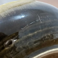 Soholm Keramik（スーホルム・セラミック）が手掛けたモデル1214のテーブルランプは、艶やかなブラウンの釉薬と段状のレリーフが生む豊かな表情が魅力で、陶磁器ならではの重量感と温かみが空間に落ち着いた存在感をもたらす北欧ビンテージ品です。柔らかな光を透過するリネンシェードがやさしい灯りを広げ、ベッドサイドやリビングのアクセント照明として取り入れやすく、経年の風合いが一層味わいを深めています。