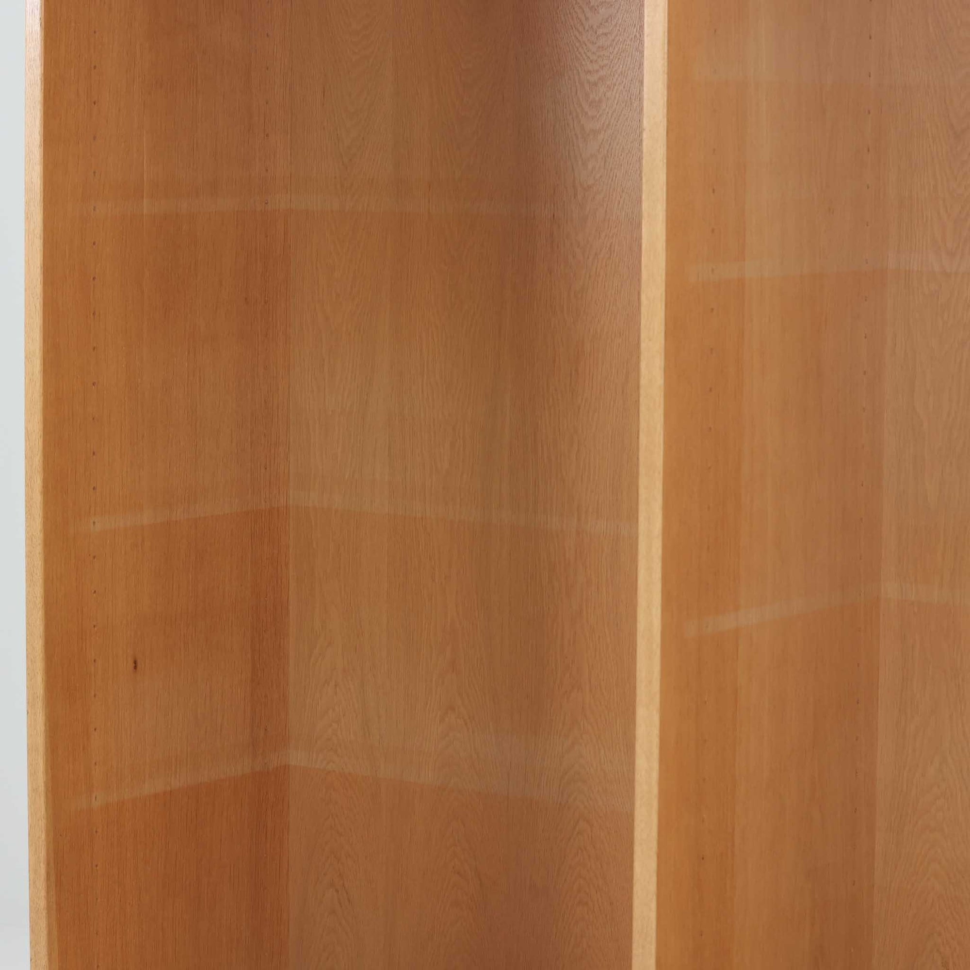 Borge Mogensenがデザインし、Karl Andersson &amp; Sonerが製作したブックシェルフです。オーク材の穏やかな木目を活かした直線的なフォルムは、無駄を削ぎ落としたモーエンセンらしい実直な美しさを感じさせます。幅135cmのゆとりあるサイズで、左右に分かれた収納部には可動棚を備え、書籍や器、オブジェまで柔軟にレイアウト可能。経年により深みを増した木肌が空間に温かみを添える、北欧ビンテージならではの堅実な一台です。