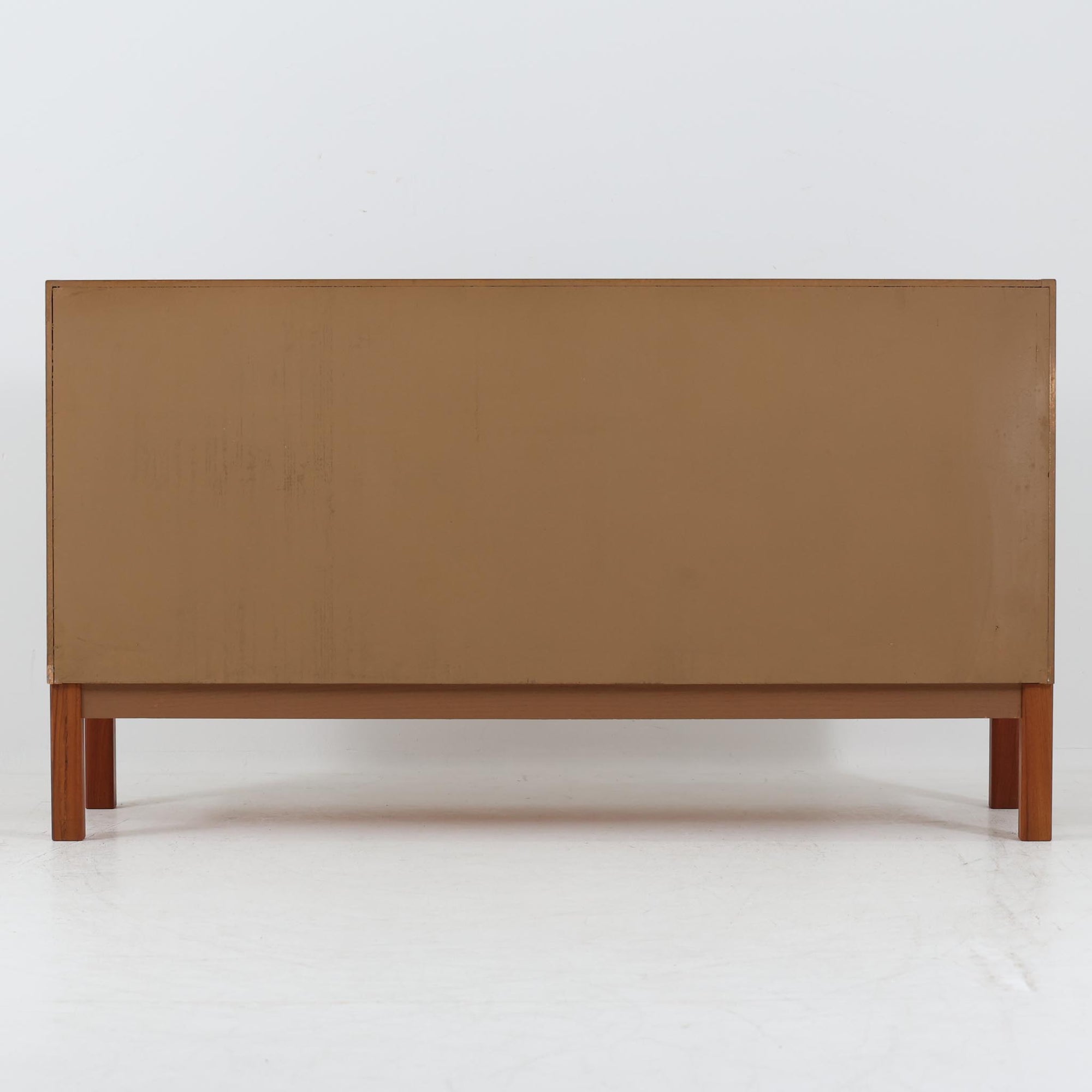 Nils JonssonがTroedsのためにデザインした「Domi Monte」モデルのキャビネットは、チーク材の豊かな木目と端正な框扉が魅力の北欧ビンテージ家具で、内部には可動棚を備えた左右対称の収納スペースが広がり食器や書類、小物類をすっきりと整理でき、チーク材をジョイントした鍵が細部の意匠性を高めつつ、直線的でシンプルな構造に細身の脚部を組み合わせることで軽やかな印象を生み出し、1960年代スウェーデン家具らしい上質で実用性の高いデザインが空間に落ち着いた存在感を添え、経年で深まった木肌の美しさも相まってリビングやダイニングのサイド収納として幅広く活躍する一台です。