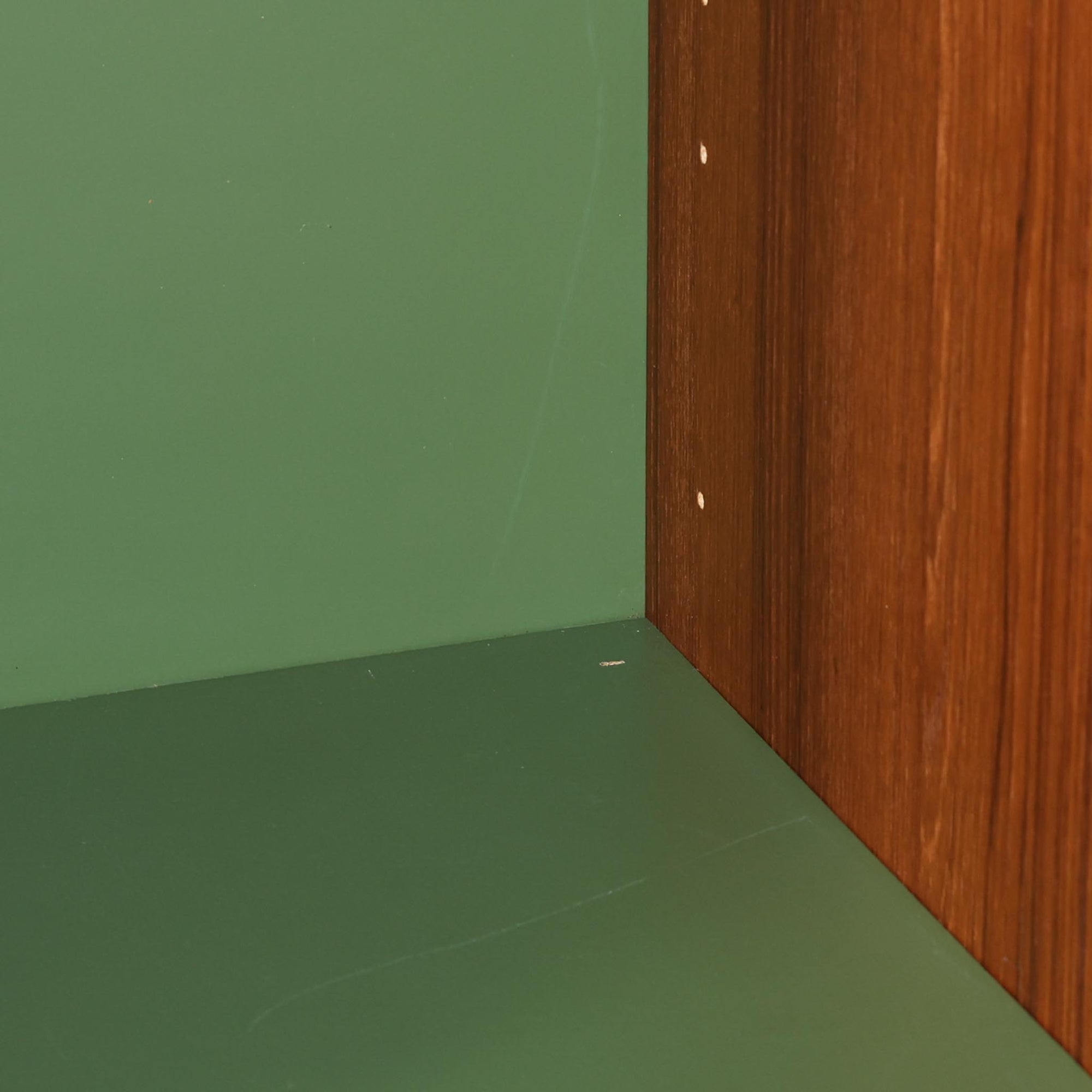 B.フリードホーゲンがデザインし、Bodafors社により製作された北欧ビンテージのディスプレイシェルフです。チーク材の美しい木目を活かした縦に伸びる端正なフレーム構成が印象的で、オープン棚と下部収納を組み合わせた実用性の高いデザインとなっています。上段は抜け感のある棚板構造で、書籍や器、オブジェを軽やかに飾ることができ、下段の引き戸収納は生活感の出やすい物をすっきりと収められます。脚付きによる軽快な佇まいと、経年変化によって深みを増した素材感が、空間に北欧ビンテージならではの落ち着いた存在感を与えます。