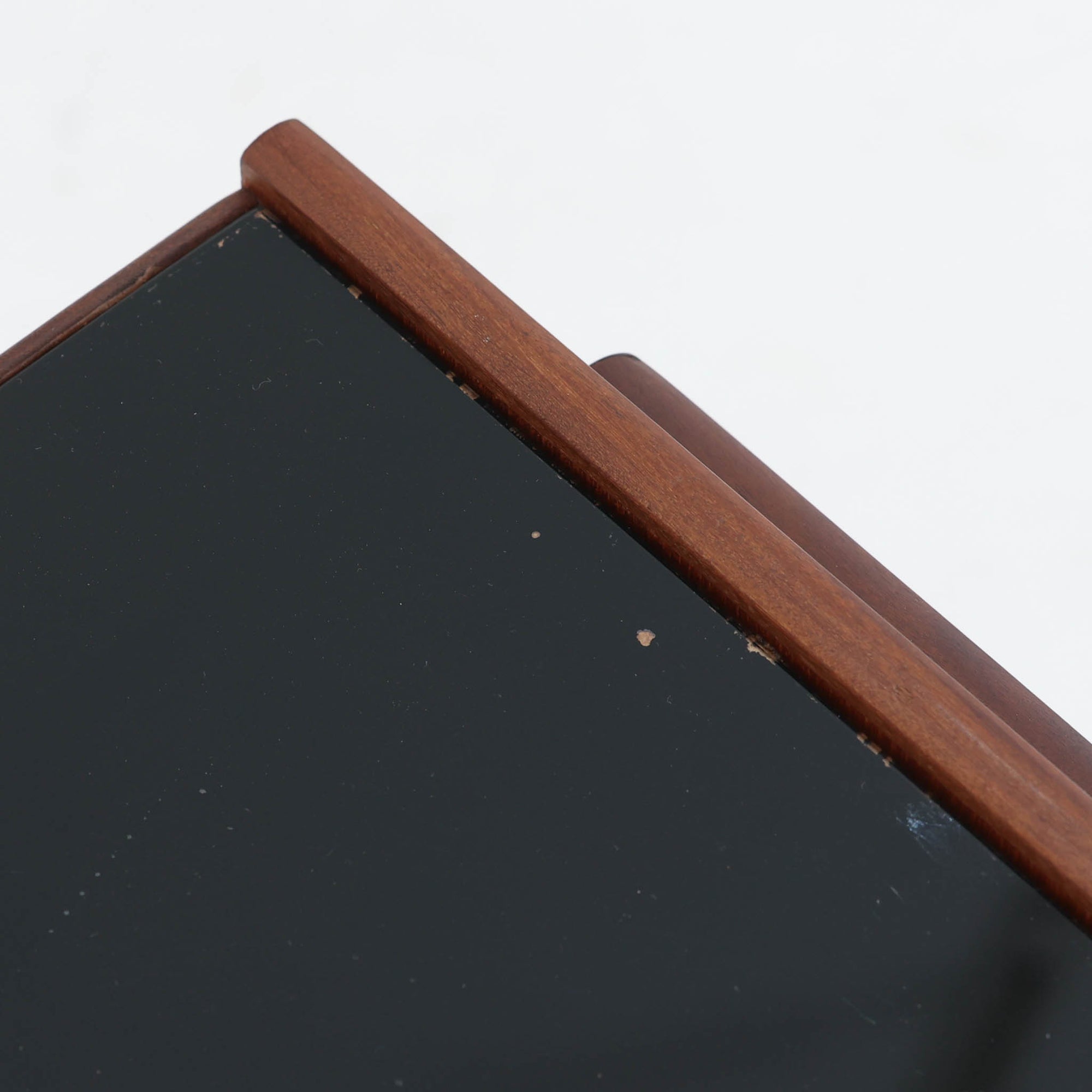 Arne Vodderがデザインし、Olholm Mobelfabrikで製作されたサイドテーブルです。温かみのある木部フレームと軽やかな印象の天板構成が美しく調和し、北欧らしい洗練された佇まいを演出します。曲線を描く幕板の意匠や丸みを帯びた脚部など、随所に職人技が感じられる丁寧なつくりも魅力。ソファ横やベッドサイドでの小物置きやランプ台として活躍し、経年により深みを増した素材感が空間に上質なアクセントを添えるビンテージ家具です。