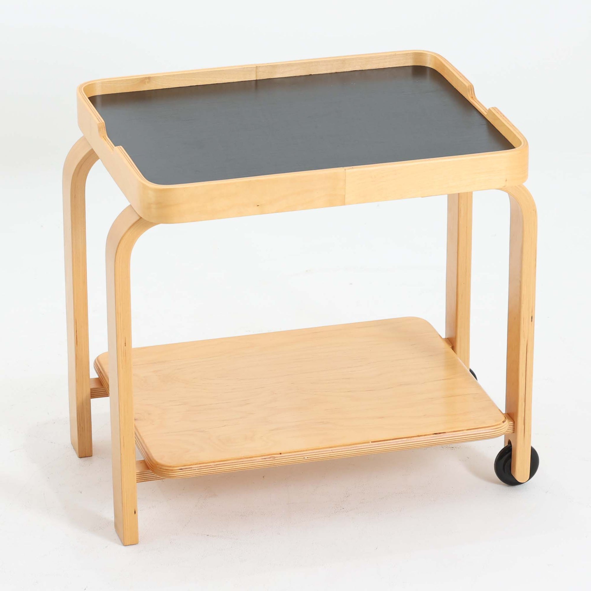 Carina Bengsがデザインし、IKEAで製作された「Brunabo」シリーズのキャスターワゴンです。バーチ材を使用した明るくやわらかな木目が特徴で、北欧らしいシンプルで温かみのあるデザインに仕上げられています。2000年代に製作されたモデルで、現在はすでに生産終了していると考えられ、ビンテージとして楽しめるアイテムです。上段は取り外し可能なトレイ仕様になっており、飲み物や小物を運ぶサービングトレイとしても使用できる実用的な構造。トレイを外した状態でも天板として使えるため、用途に応じた使い方が可能です。下段には棚板が設けられており、雑誌やキッチン用品、日用品などを収納できます。また片側のみにキャスターが付いた設計になっているため、一般的なワゴンよりも安定感があり、必要な時だけ持ち上げて移動できる使い勝手の良さも魅力。リビングやダイニング、キッチンなどさまざまな空間で活躍する、北欧らしい機能性とデザイン性を兼ね備えたワゴンです。