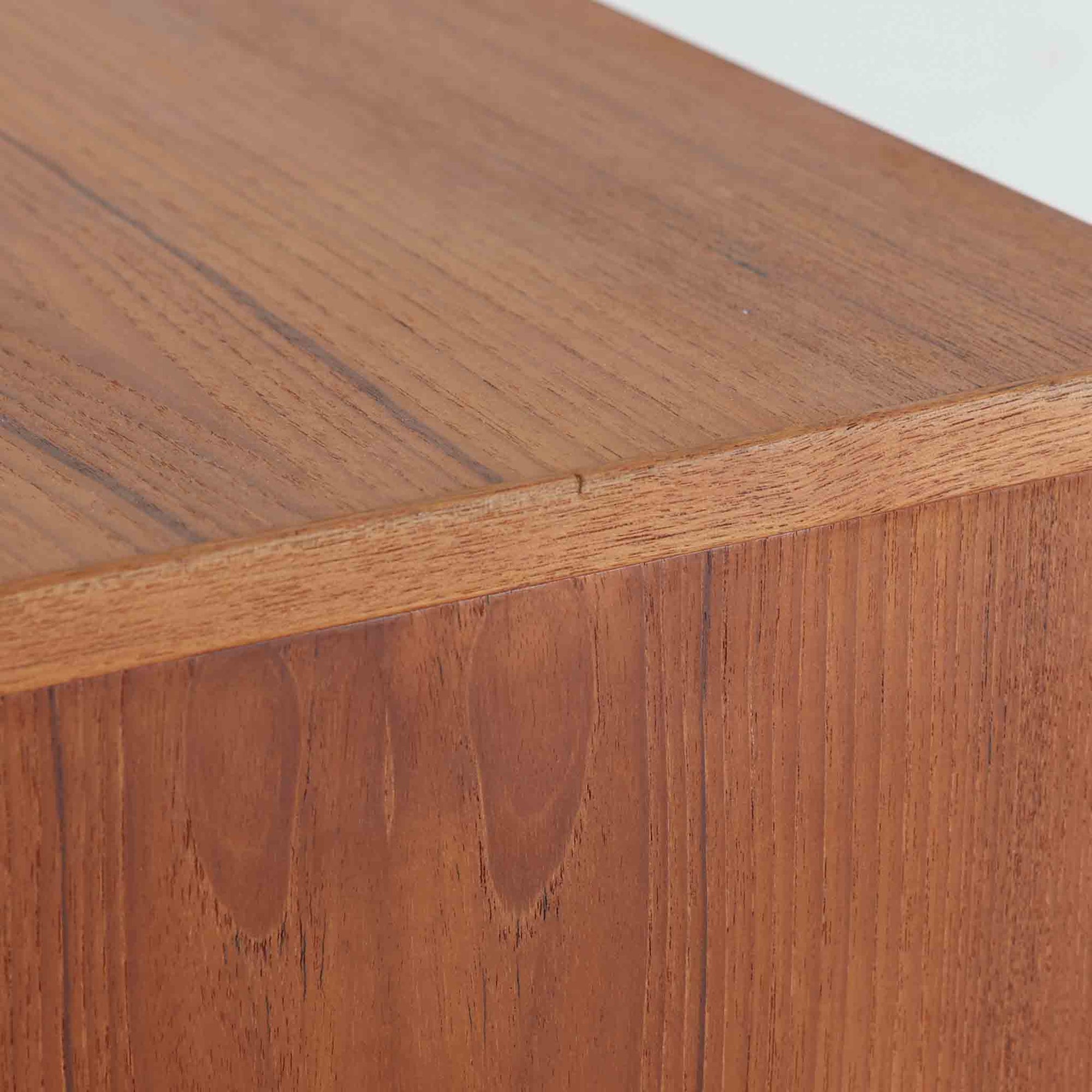 良質な木材を使用した本体は、美しい木目と経年により深みを増した色艶が魅力で、空間に落ち着いた存在感をもたらします。コンパクトなサイズ感ながら、引き戸内部には可動棚やトレイ収納を備え、食器や書類、小物を機能的に整理できる実用的な設計。すっきりとしたフォルムに対し、わずかに外側へ広がる脚部が軽やかさと安定感を両立し、ビンテージならではの丁寧な作りと佇まいを感じさせます。リビングやダイニングの収納家具としてはもちろん、ディスプレイ台としても活躍する一台です。