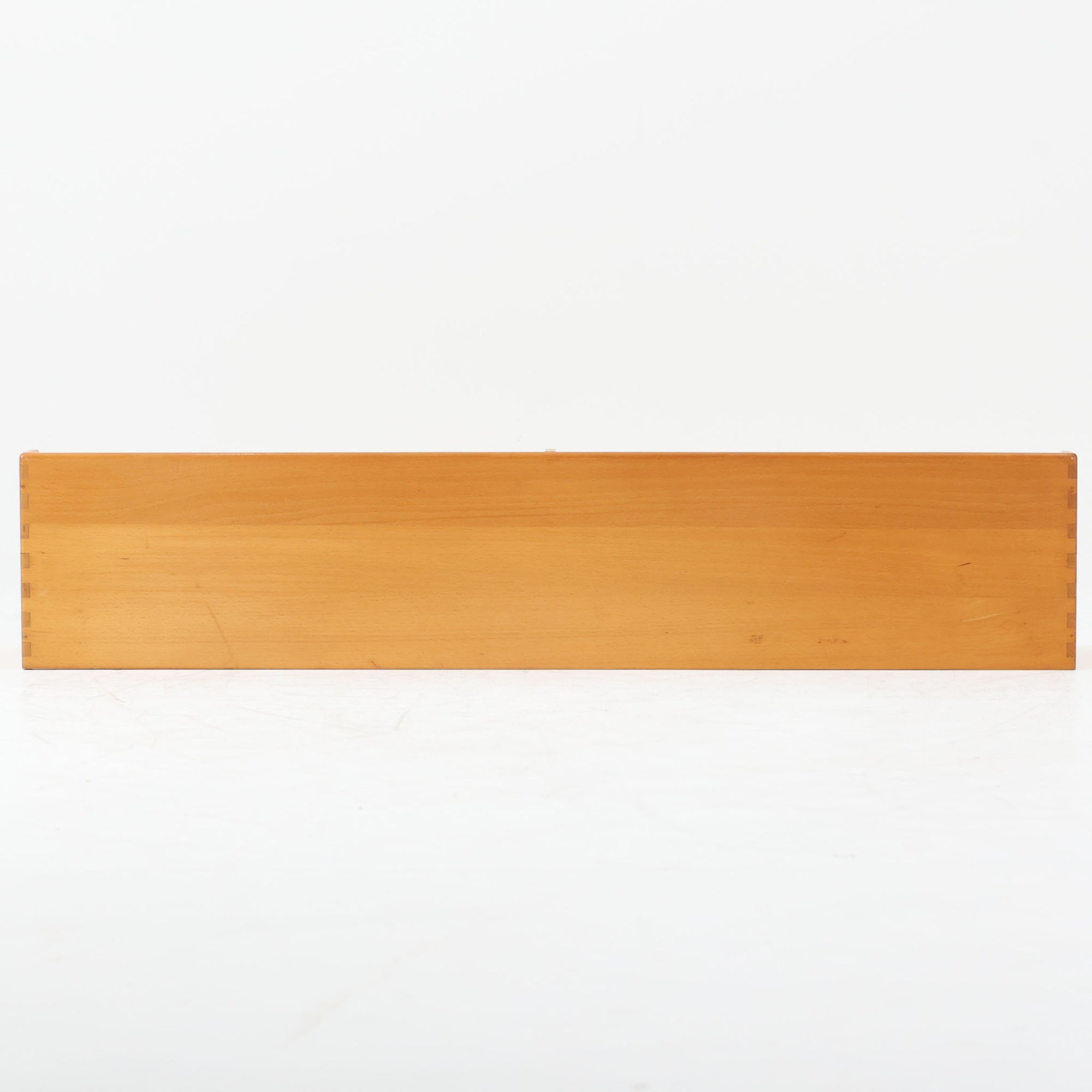 Borge Mogensen（ボーエ・モーエンセン）デザイン、FDB Mobler製のウォールシェルフ Model B5です。ビーチ無垢材を使用したシンプルで温かみのあるデザインが特徴で、北欧家具ならではの機能性と美しさを兼ね備えています。両サイドのパネルと背面のバー構造により、収納物が安定しやすく、実用性の高い設計となっています。中央の仕切りによって本や小物を整理しやすく、キッチンやリビング、書斎などさまざまな空間で活躍します。素朴で飽きのこないフォルムは、モーエンセンの「日常生活のための家具」という思想を体現したデザイン。デンマーク製の北欧ビンテージならではの味わい深い木の質感が魅力の一品です。