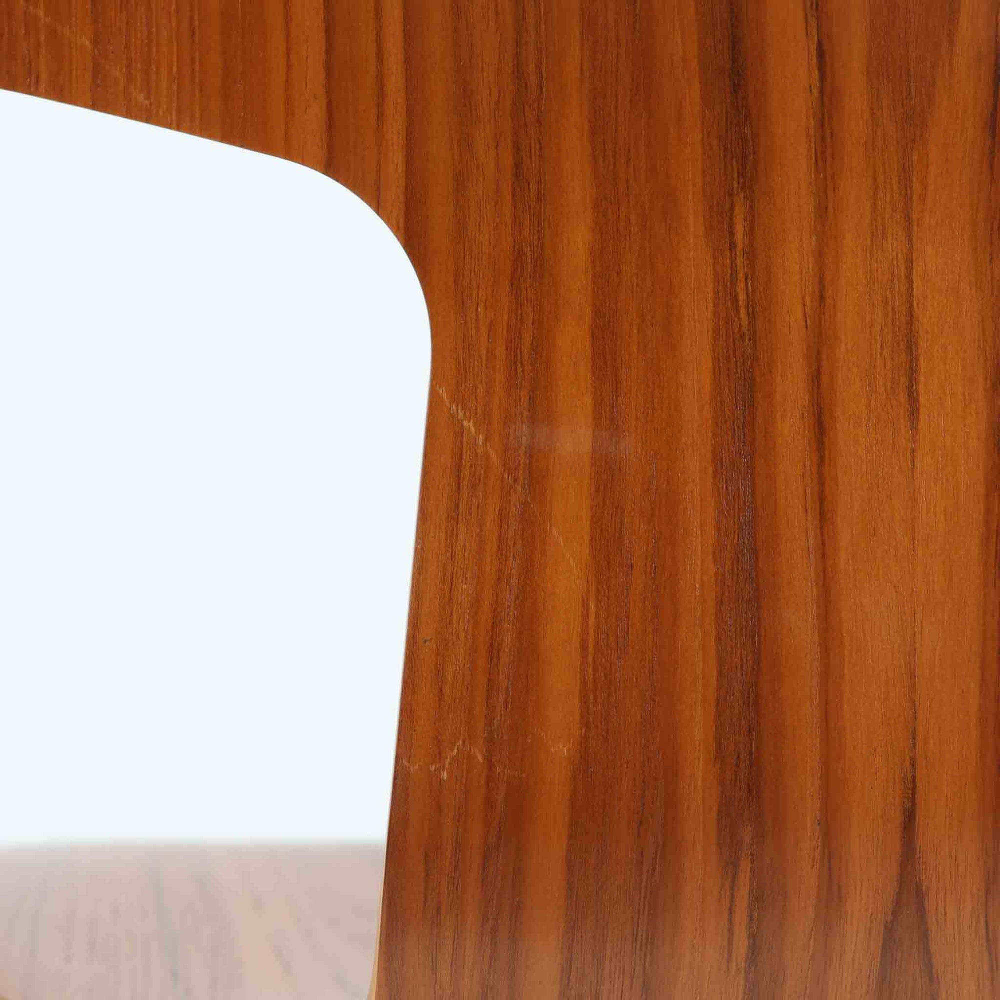 アルネ・ヤコブセンがデザインし、Fritz Hansenが製造した「T Chair」です。チーク材の成形合板による背座一体型のシェルは、背面上部を左右に広げた特徴的なシルエットと、身体に沿う緩やかな曲面が魅力。細身の金属脚との組み合わせが軽快で、ダイニングはもちろん、書斎や玄関のアクセントチェアにもおすすめです。美しい木目と時を重ねた風合い、合理的な構造に宿る北欧ビンテージらしい存在感を楽しめます。