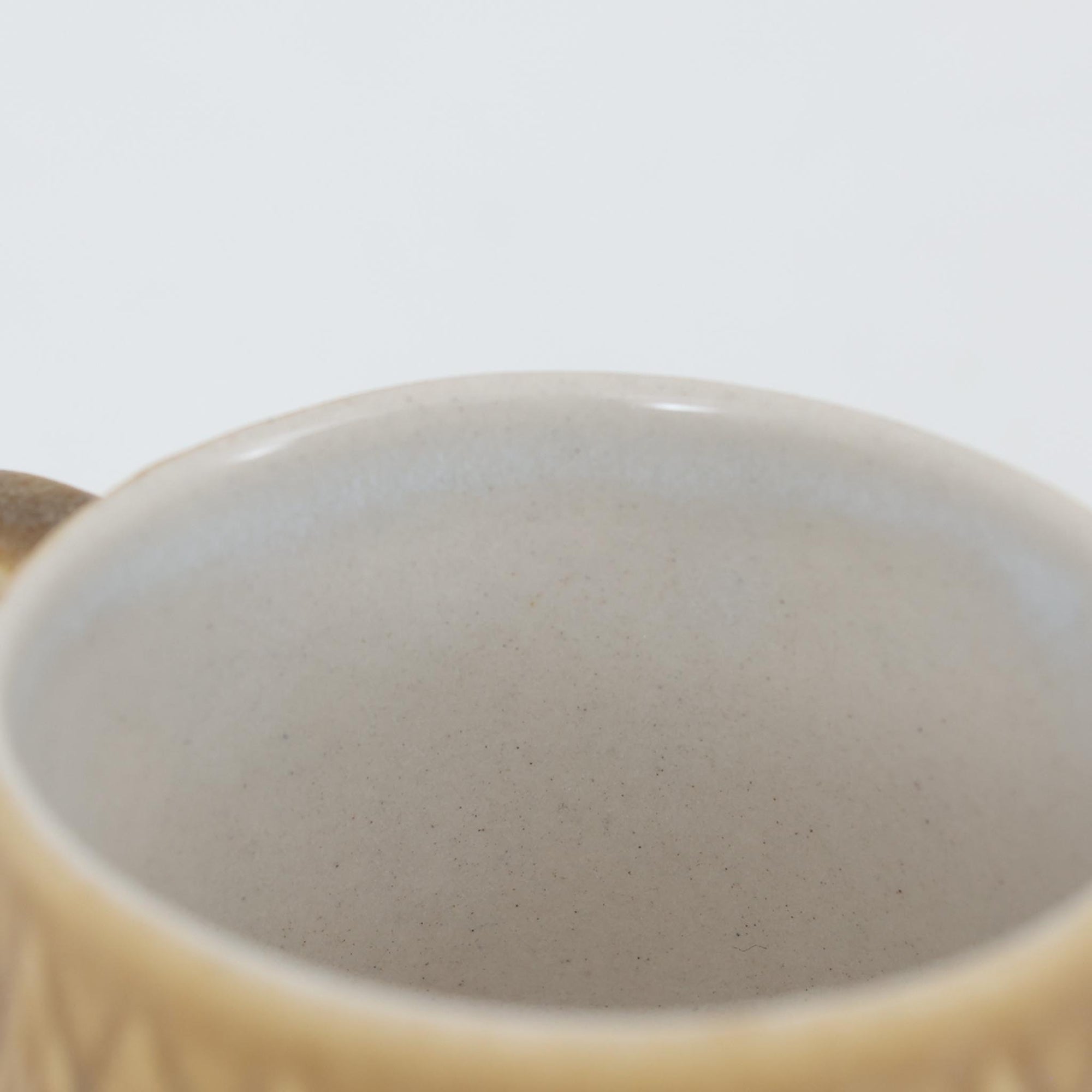 デンマークを代表するデザイナー、イェンス・H・クイストゴーによる「Relief（レリーフ）」シリーズのヴィンテージカップ&ソーサーです。マットなベージュ釉薬に丹念に浮かび上がる葉や木々の〈レリーフ〉装飾が印象的です。素朴で温もりある厚みのあるフォルムは、北欧の静かな森の風景を感じさせます。デンマークではスウェーデンやフィンランドの陶器メーカーと並んで今でも非常に人気のある商品となります。