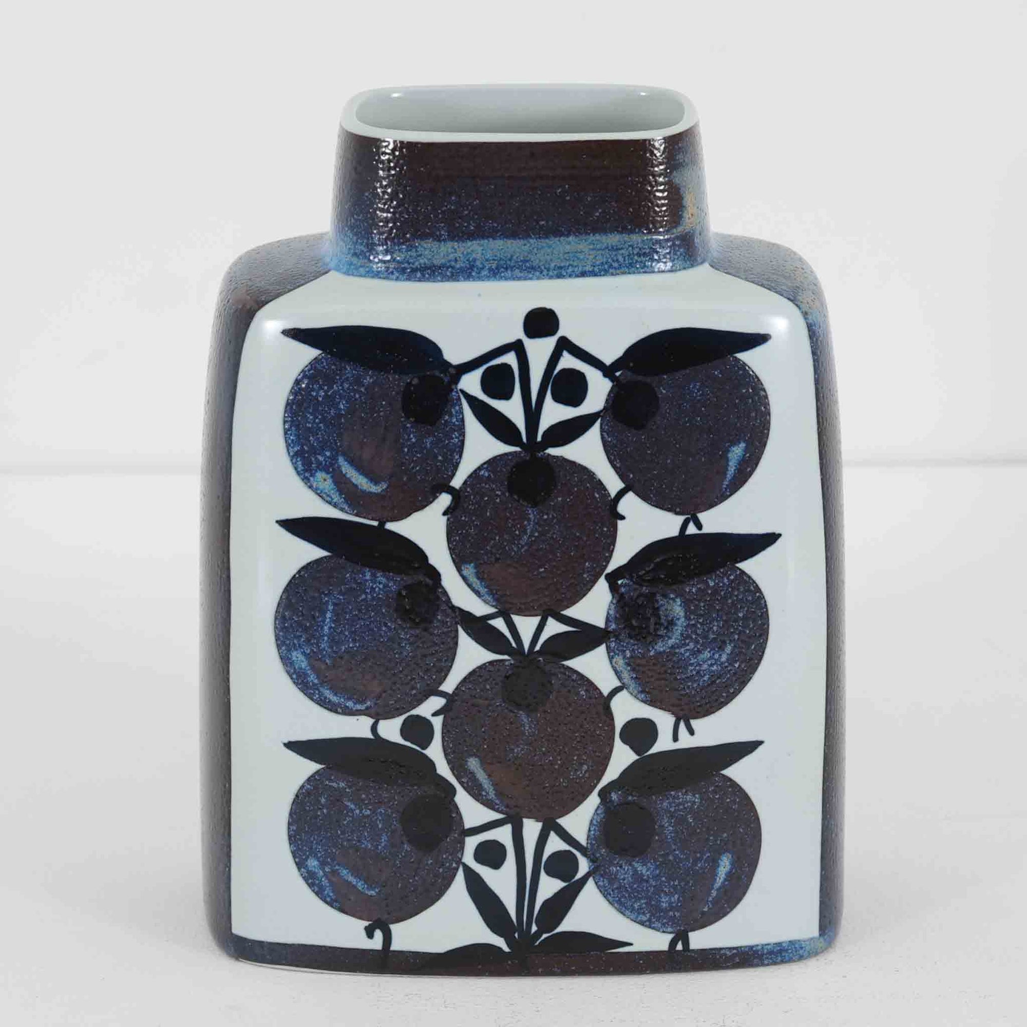 ロイヤルコペンハーゲンの「Tenera」シリーズは、1958年に誕生し1969年以降はRoyal Copenhagenブランドとして展開された、北欧モダンを象徴するファイアンスの名作です。このシリーズの魅力は、アーティスティック・ディレクターのニルス・トーソンが生み出したフォルムに、そこで活躍した女性デザイナーたち（マリアンヌ・ジョンソンやグレーテ・ヘランド＝ハンセン、カリ・クリステンセンなど）が手がけた手描きの大胆で鮮やかな絵付けが融合している点にあります。手仕事ゆえの微妙な色ムラやクラック（クレイジング）は経年変化として味わい深く、花を一輪挿すだけでリビングやダイニングに北欧ならではの温かみとモダンな華やかさを添えます。コレクターはもちろん、日常のインテリアに上質な彩りをプラスしたい方にもおすすめの逸品です。