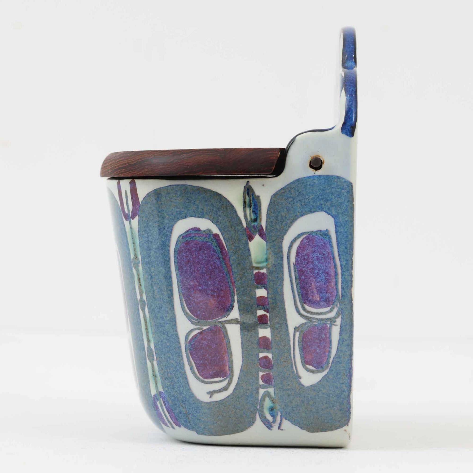 ロイヤルコペンハーゲンの名作「Tenera（テネラ）」シリーズは、1958年〜1970年代にかけて製造されたヴィンテージファイアンスの代表格。名匠ニルス・トーソンの指揮のもと、インゲ・エクスナーやベアテ・アンダーセン、マリアンヌ・ジョンソンなど、当時の若き女性アーティストたちが手がけた芸術性の高いコレクションです。艶やかな釉薬に施されたハンドペイントとシルクスクリーンの融合が、植物や抽象モチーフを繊細かつ大胆に表現。ブルーを基調とした豊かな色彩と有機的なフォルムが、北欧デザインの洗練と温かみを兼ね備えています。