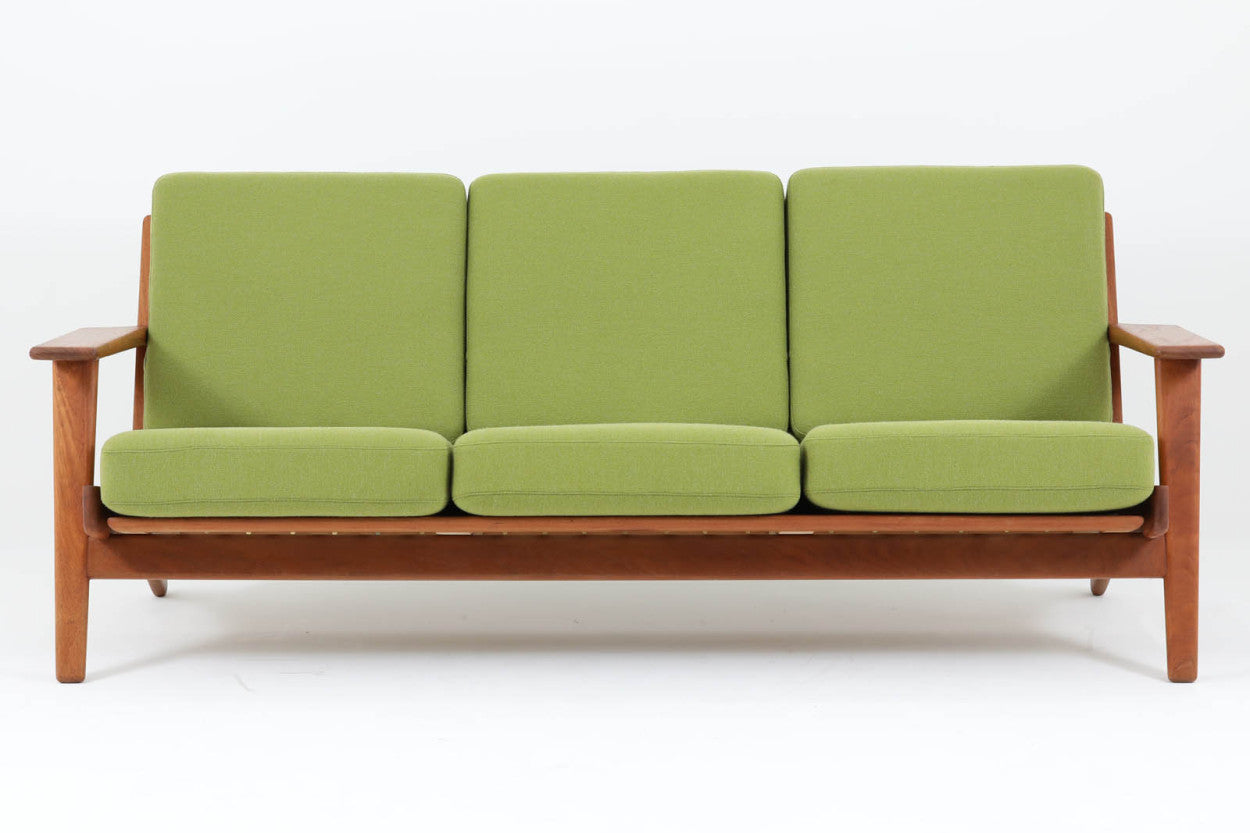 北欧家具を代表するソファ『GE290』です。現在リプロダクト品が販売されていますが、こちらは本物です。元々はベッド会社であるGETAmA社ならではのコイルスプリングが内包されたクッションの座り心地は、弾力があり心地良く、読書や映画などのリラックスタイムに最適です。立ち上がる際も適度なはね返りがあるので、動く時に億劫になる事はありません。HansJ.Wegnerならではの時代を超えた素晴らしいデザインです。横や背面から見るとまた違った表情を感じて頂けると思います。こちらは現行品では手に入れる事が出来ない、チーク材の非常に希少なモデルです。