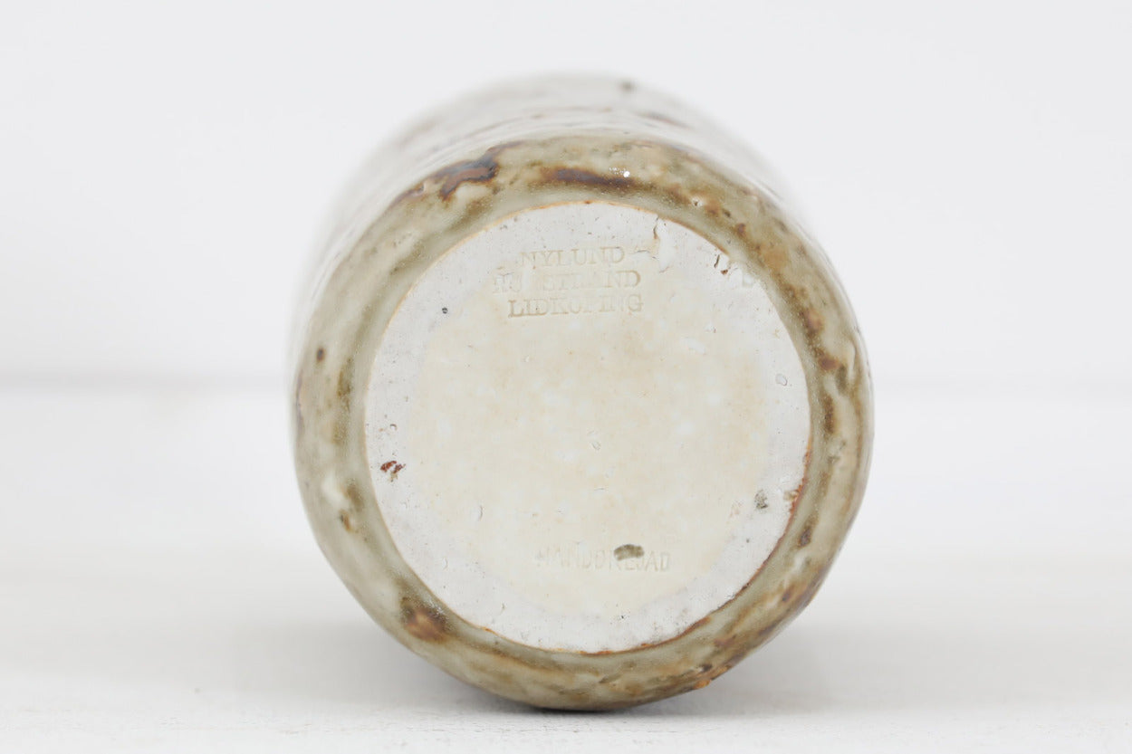 フィンランド人で彫刻家の父と、デンマーク人で陶芸家の母の元に育つGunnarNylundはデンマークで建築を学んだ後、Bing&amp;amp;Grondahl窯、スウェーデンRorstrand窯に就業し、多くの作品を生み出しています。彼の作品は独特な流線型と釉薬が特徴で世界中で重宝されています。こちらはおそらくChamotteシリーズのものになります。一般的な作品に比べてかなりどっしりしていて重量があります。