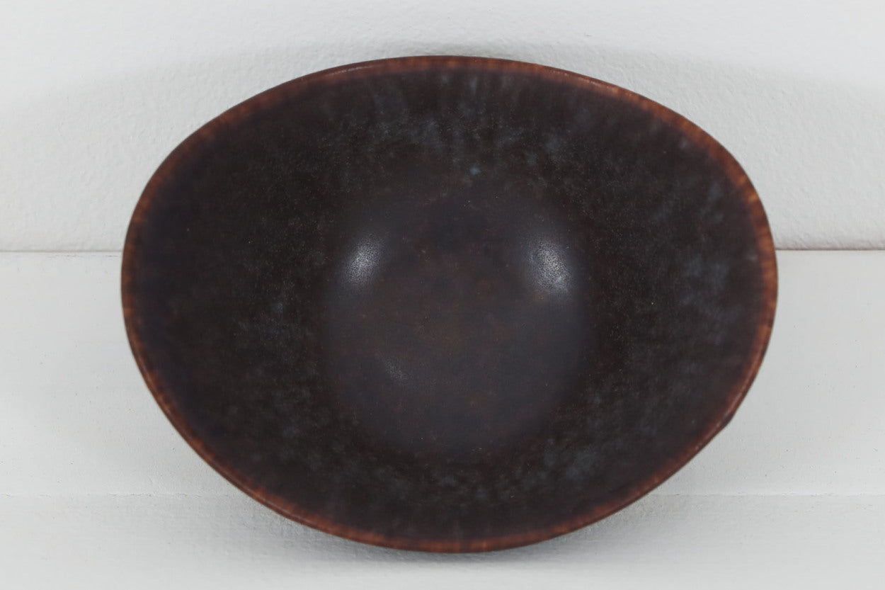 フィンランド人で彫刻家の父と、デンマーク人で陶芸家の母の元に育つGunnarNylundはデンマークで建築を学んだ後、Bing&amp;amp;Grondahl窯、スウェーデンRorstrand窯に就業し、多くの作品を生み出しています。彼の作品は独特な流線型と釉薬が特徴で世界中で重宝されています。AROボウルは彼の最も代表的な作品で、その緩やかな美しいカーブが特徴です。また、さまざまな表情をみせる釉薬がコレクターにも人気がある理由です。