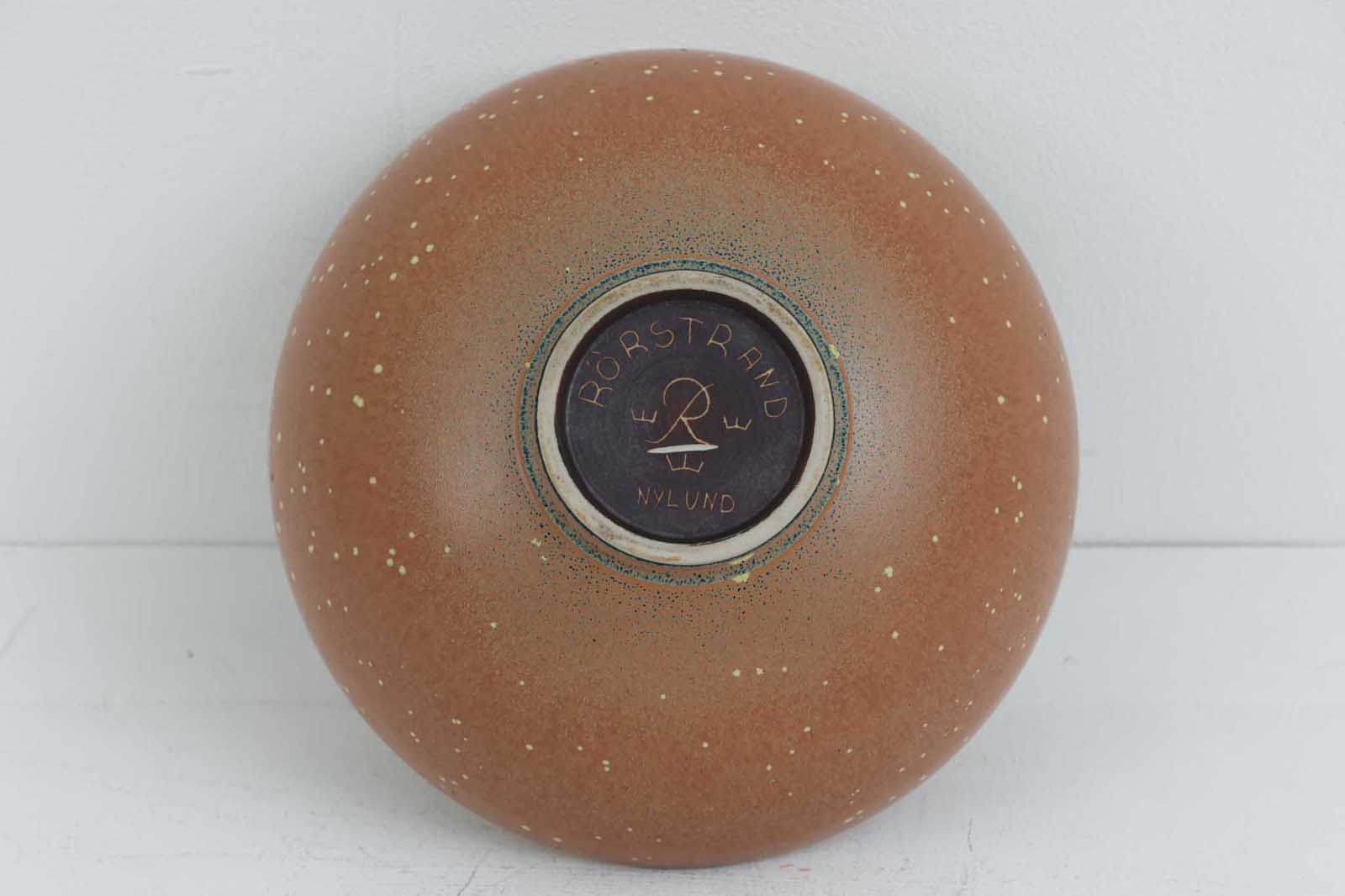 フィンランド人で彫刻家の父と、デンマーク人で陶芸家の母の元に育つGunnarNylundはデンマークで建築を学んだ後、Bing&amp;amp;Grondahl窯、スウェーデンRorstrand窯に就業し、多くの作品を生み出しています。彼の作品は独特な流線型と釉薬が特徴で世界中で重宝されています。